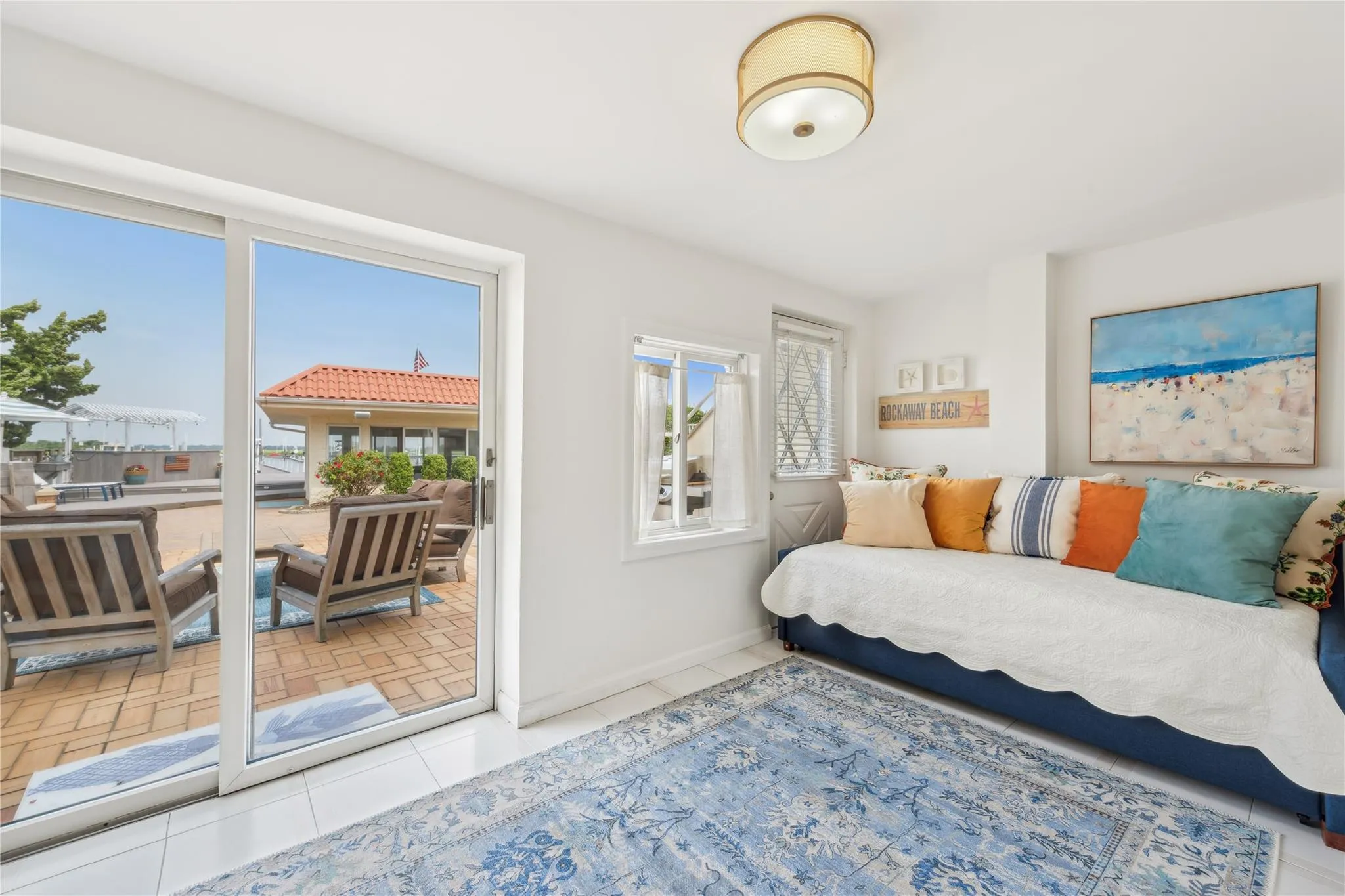 Bedroom with access to outside, multiple windows, and light tile patterned floors Bedroom with access to outside, multiple windows, and light tile patterned floors