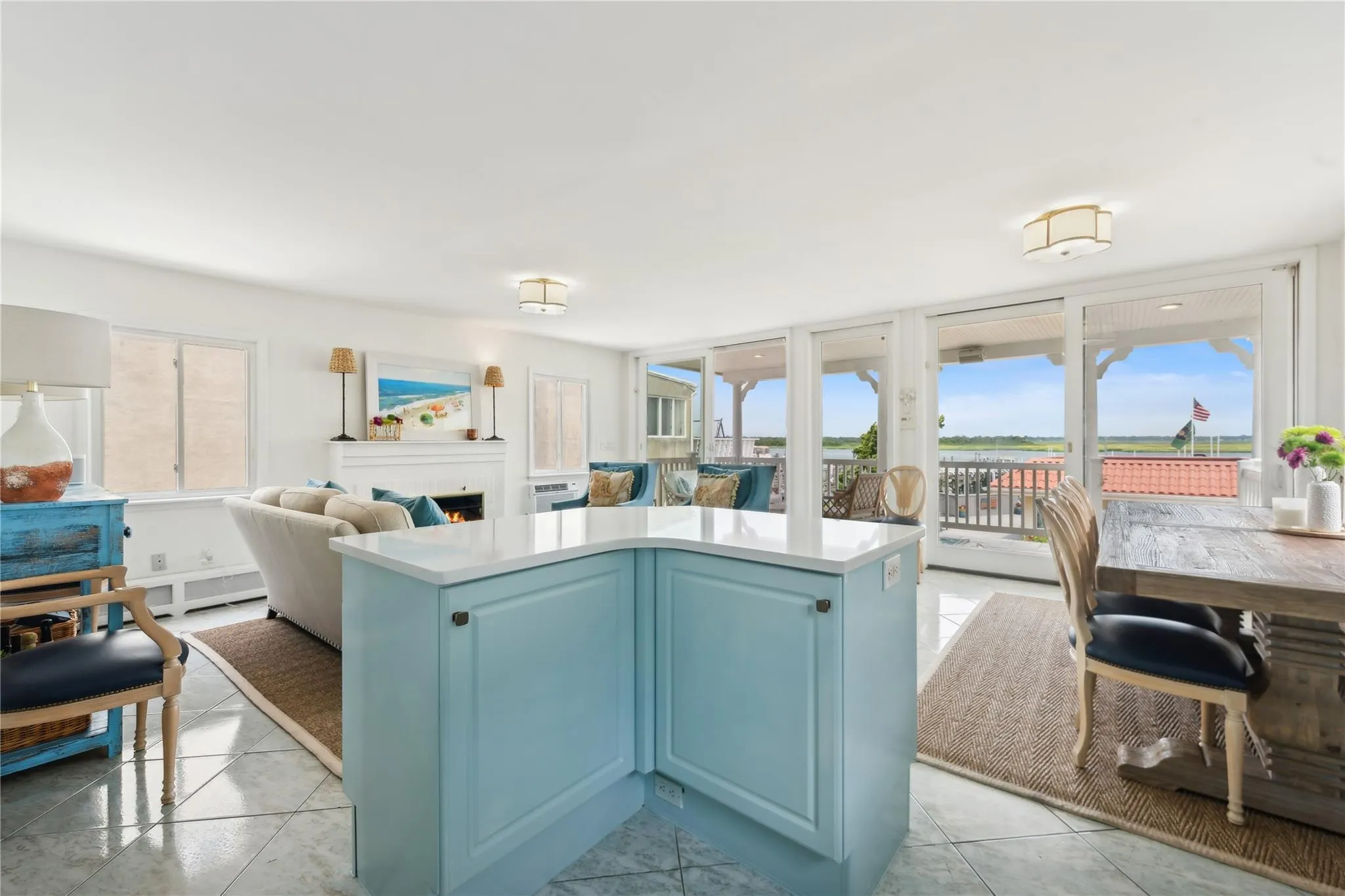 Kitchen featuring blue cabinetry, a center island, and light tile patterned floors Kitchen featuring blue cabinetry, a center island, and light tile patterned floors