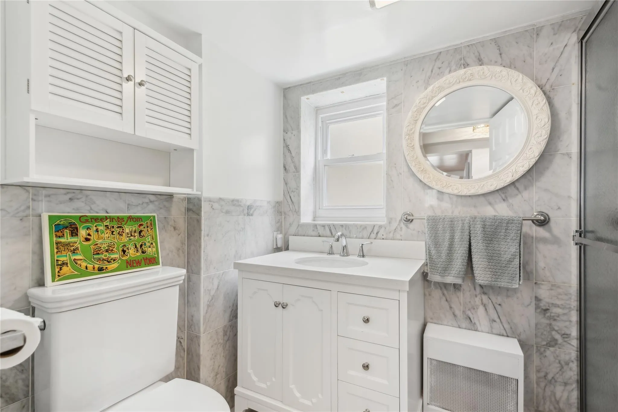 Bathroom with vanity, tile walls, and toilet Bathroom with vanity, tile walls, and toilet