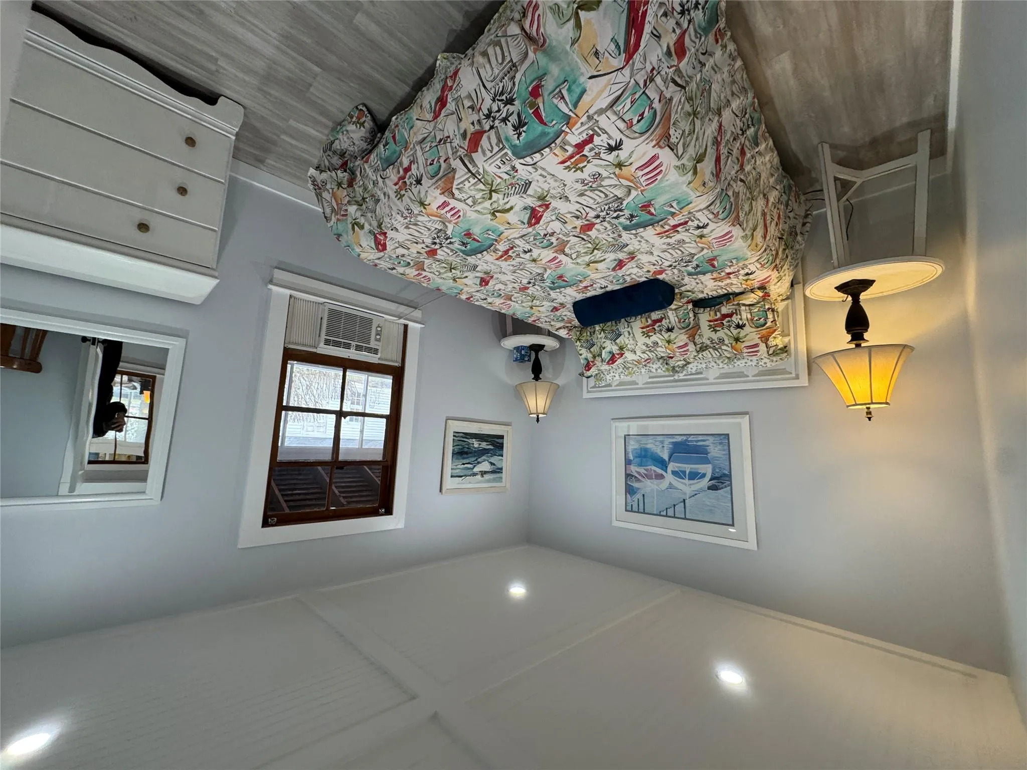 Bedroom featuring cooling unit and light hardwood / wood-style floors Bedroom featuring cooling unit and light hardwood / wood-style floors