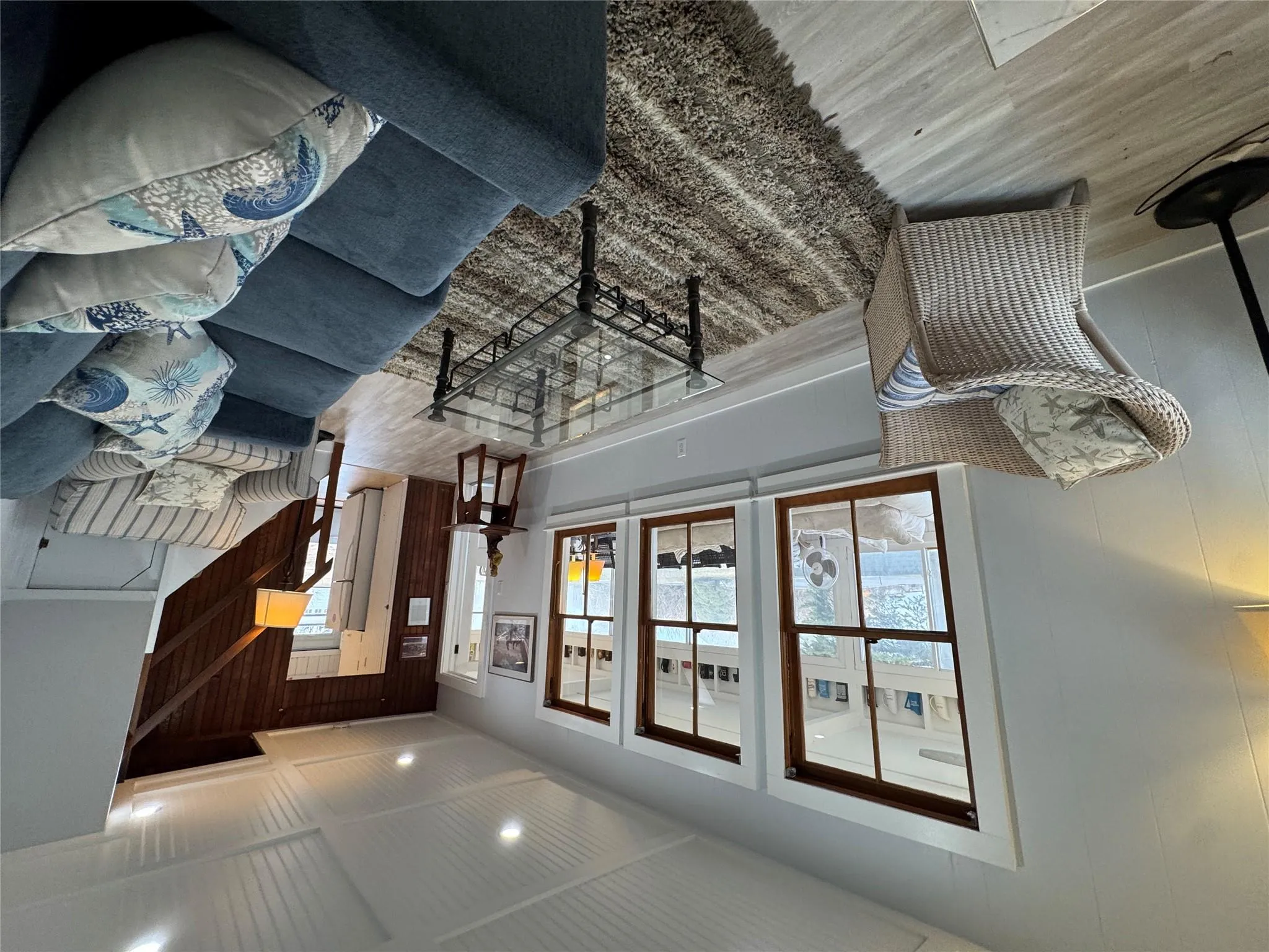 Living room featuring light hardwood / wood-style flooring and wood walls Living room featuring light hardwood / wood-style flooring and wood walls