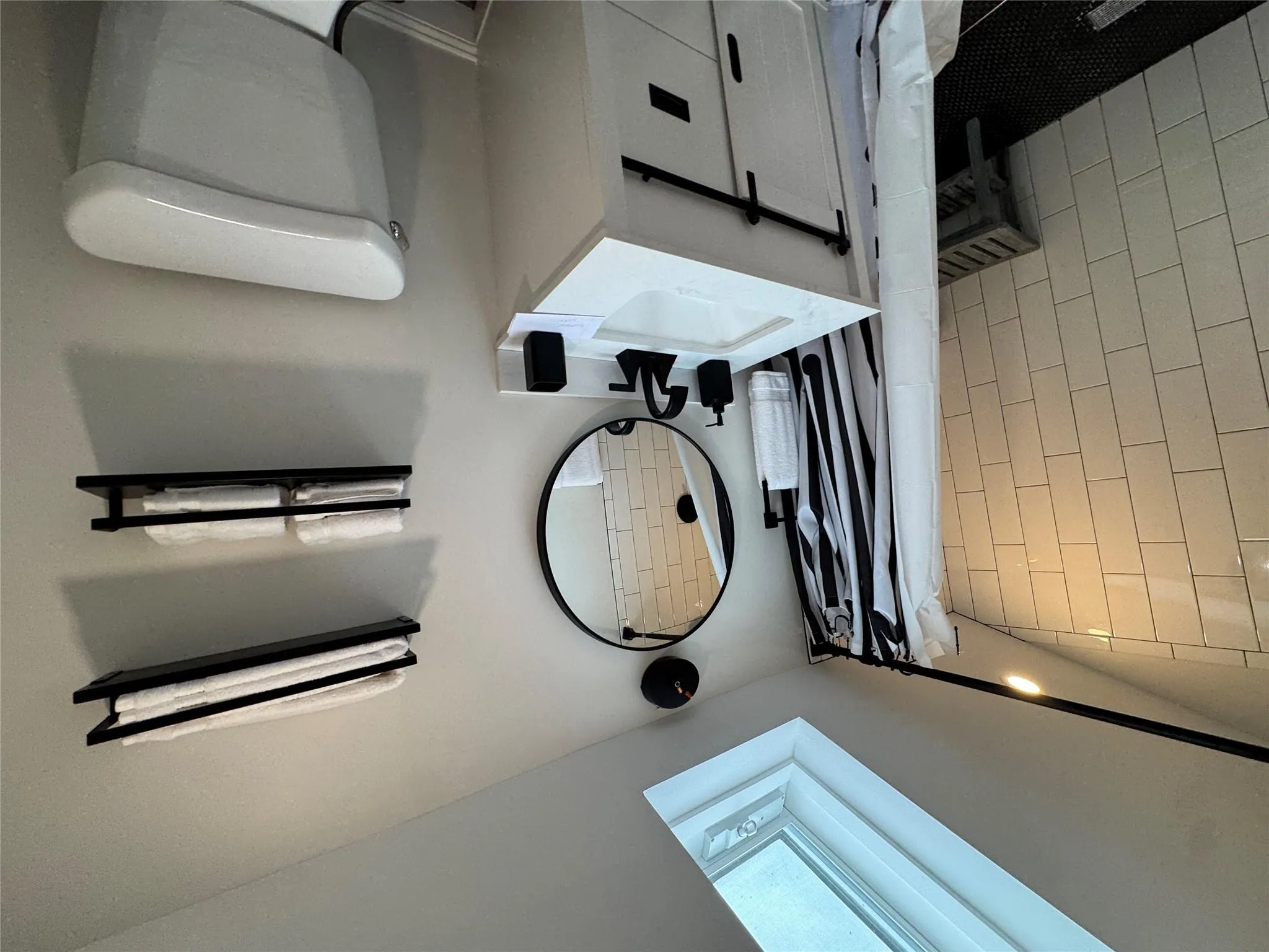 Bathroom featuring vanity, vaulted ceiling with skylight, walk in shower, and toilet Bathroom featuring vanity, vaulted ceiling with skylight, walk in shower, and toilet