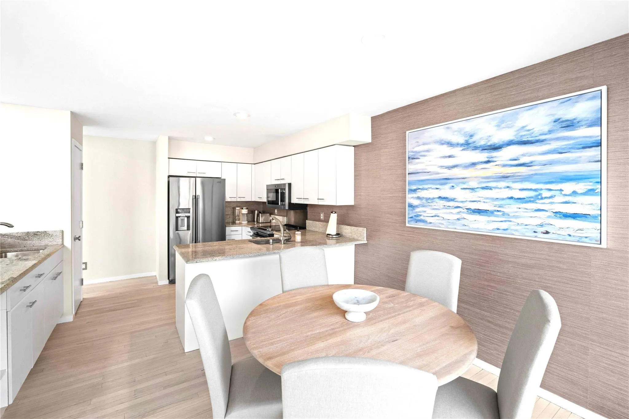 Dining room featuring sink and light wood-type flooring Dining room featuring sink and light wood-type flooring