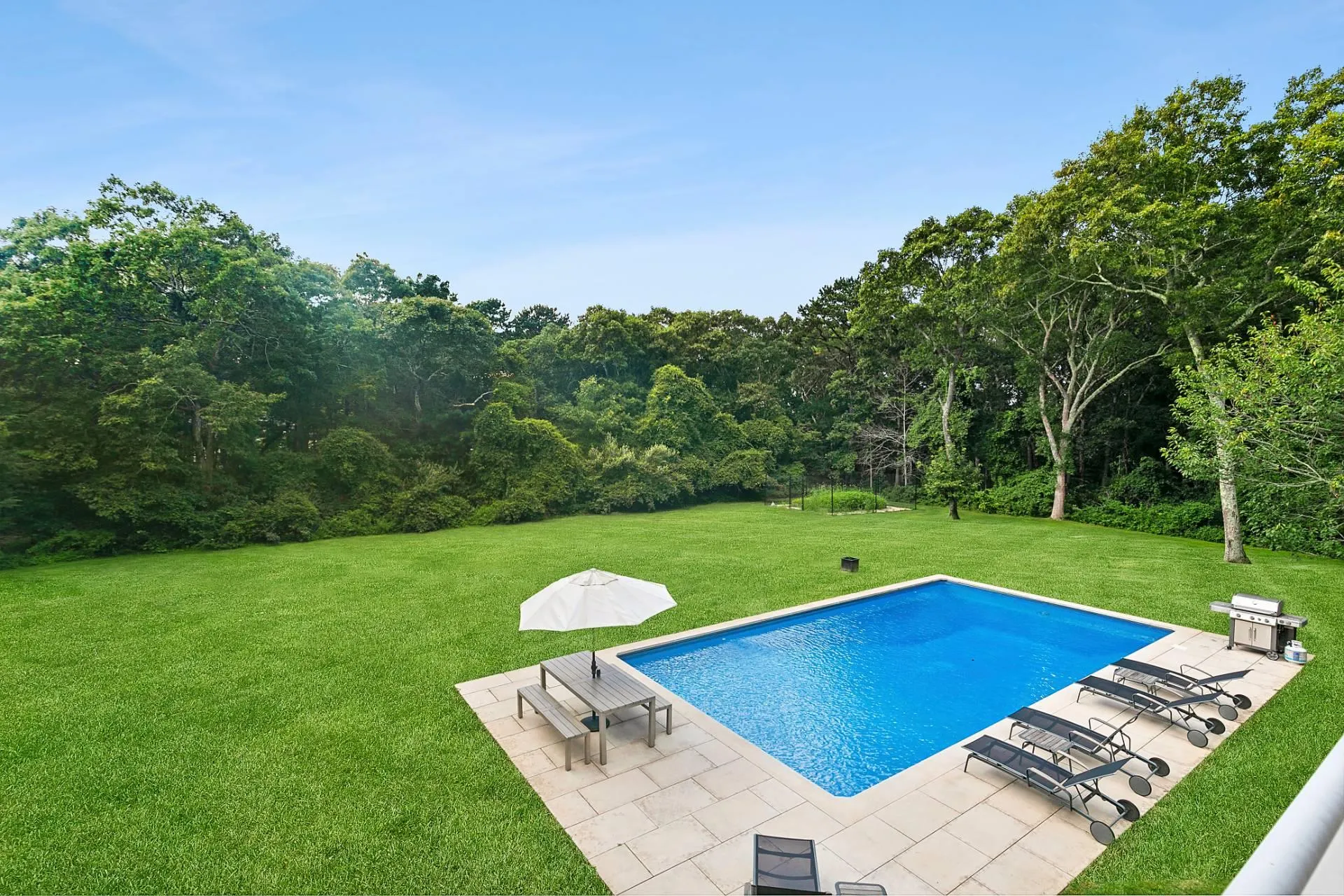 Balcony Bedroom View of pool with a patio area and a spacious lawn Balcony Bedroom View of pool with a patio area and a spacious lawn