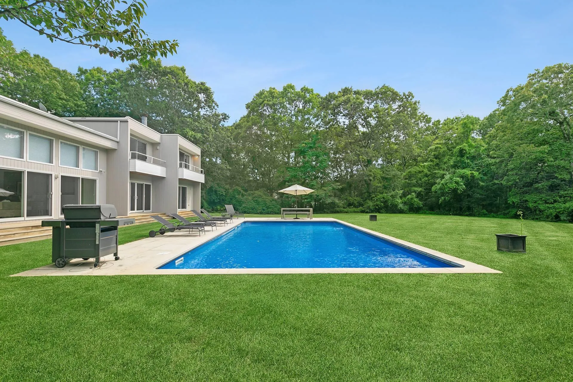 View of swimming pool with grilling area, a patio, and a lawn View of swimming pool with grilling area, a patio, and a lawn