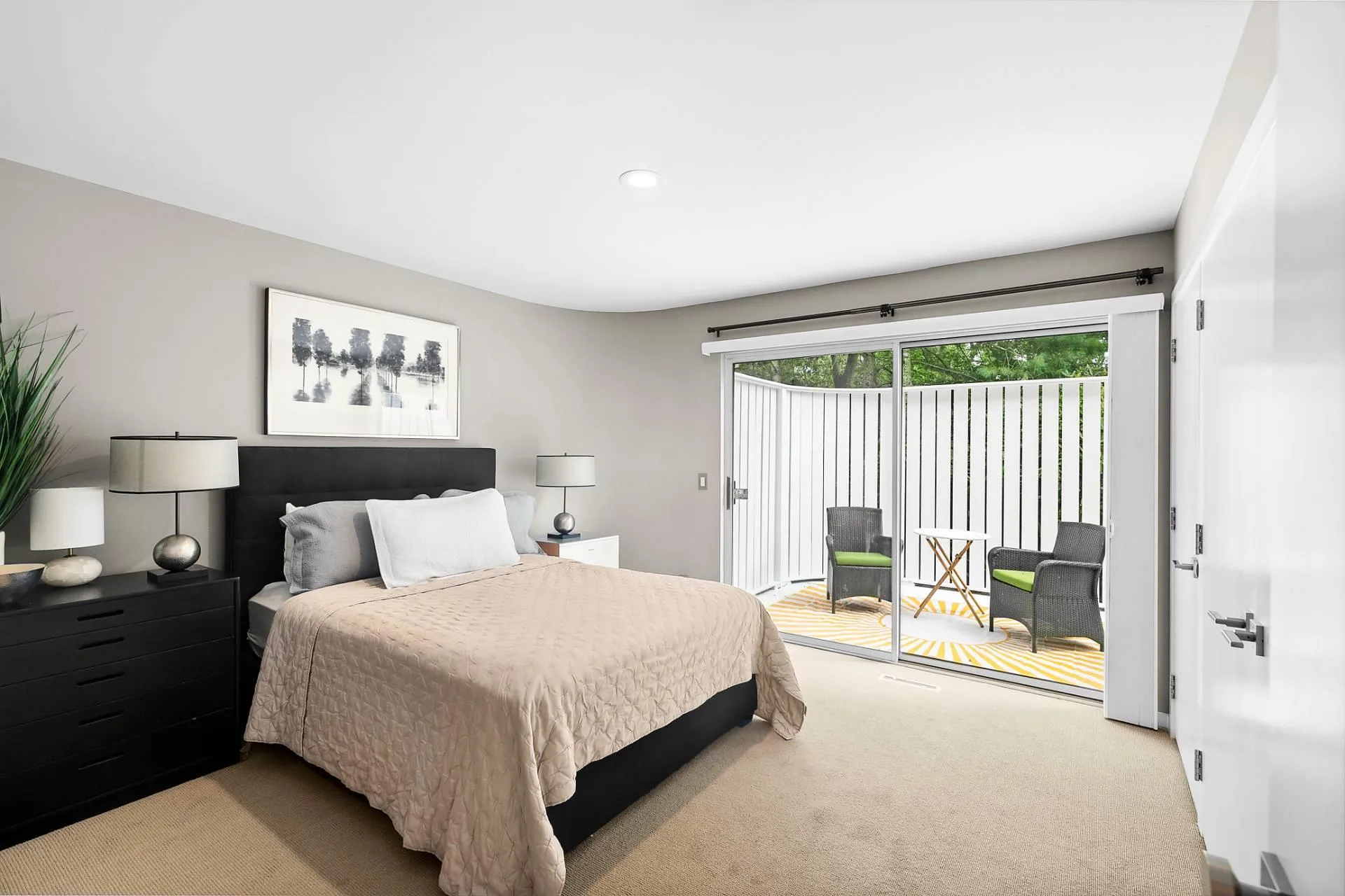 1st floor Bedroom with light colored carpet and access to outside private deck 1st floor Bedroom with light colored carpet and access to outside private deck