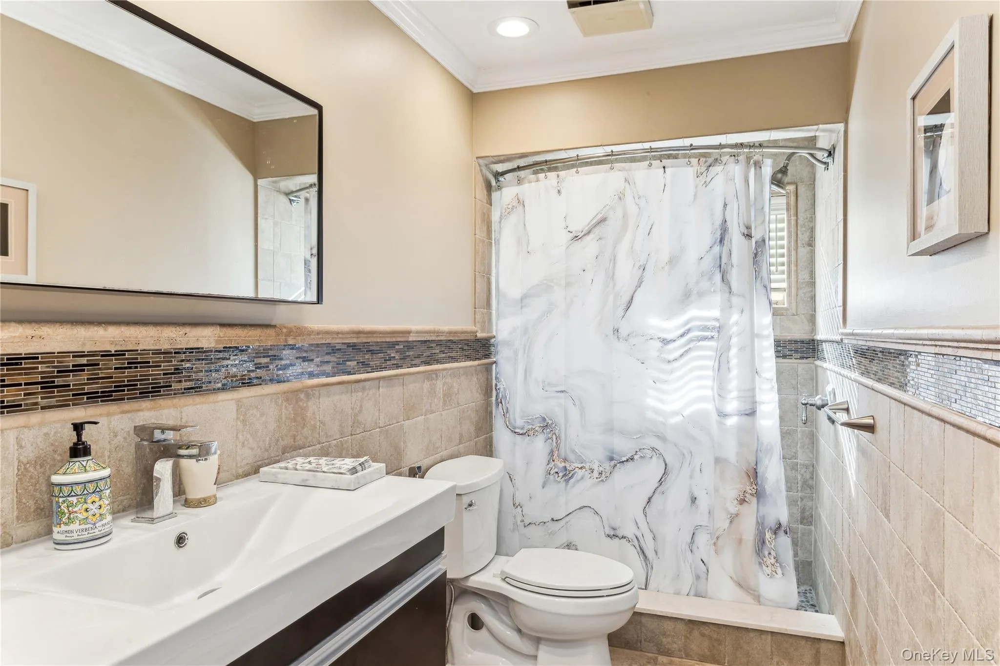 Bathroom featuring vanity, crown molding, toilet, and walk in shower Bathroom featuring vanity, crown molding, toilet, and walk in shower