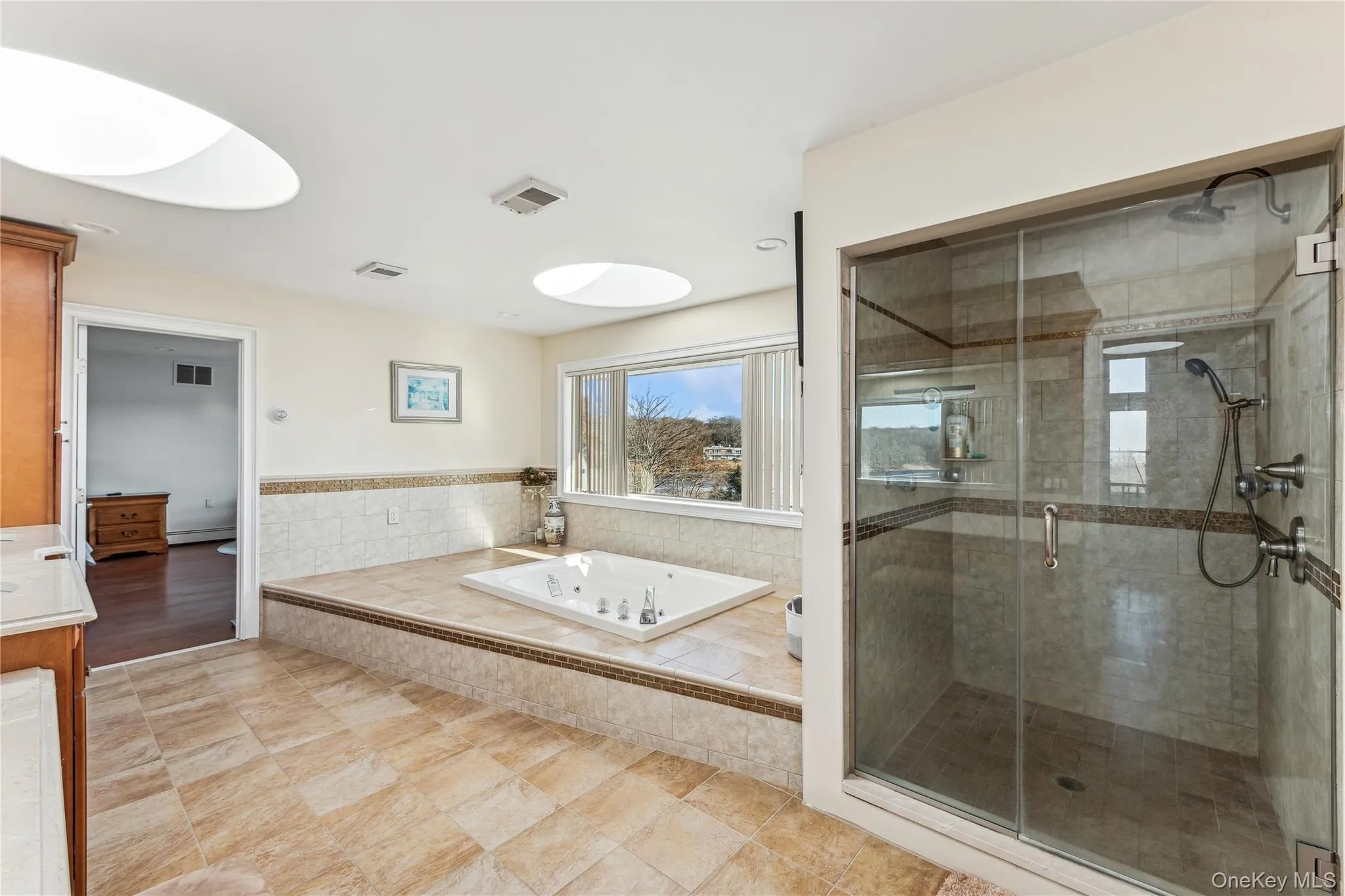 Bathroom featuring vanity and plus walk in shower Bathroom featuring vanity and plus walk in shower