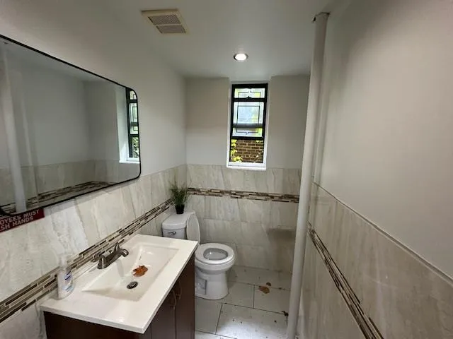 Bathroom with vanity, tile patterned floors, and toilet Bathroom with vanity, tile patterned floors, and toilet