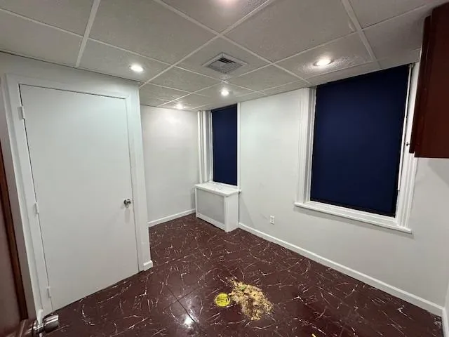 Empty room with radiator heating unit and a drop ceiling Empty room with radiator heating unit and a drop ceiling