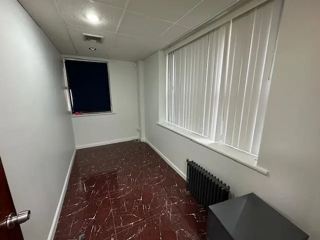 Hallway with a paneled ceiling and radiator heating unit Hallway with a paneled ceiling and radiator heating unit