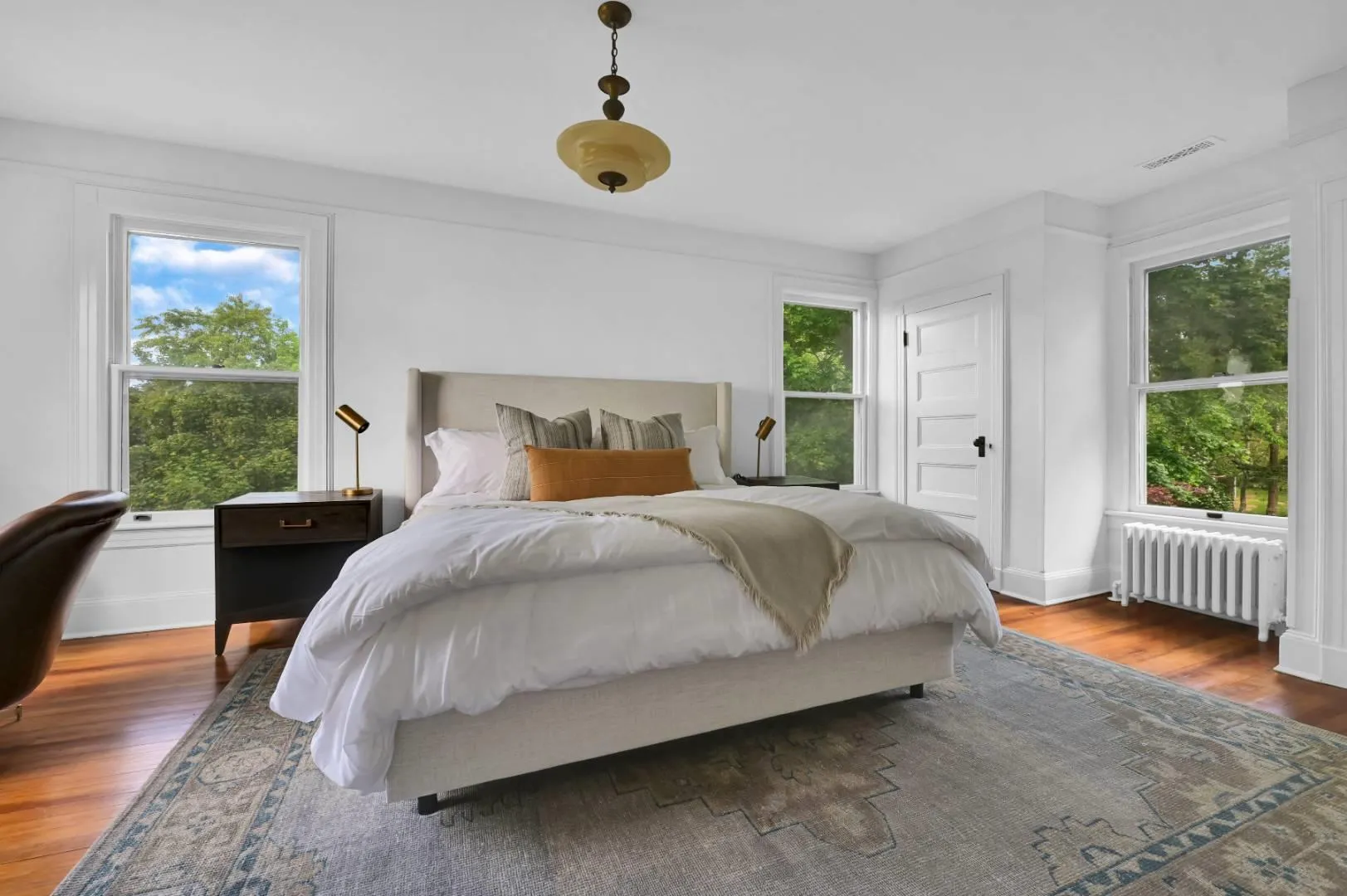 Bedroom featuring radiator and dark hardwood / wood-style floors Bedroom featuring radiator and dark hardwood / wood-style floors