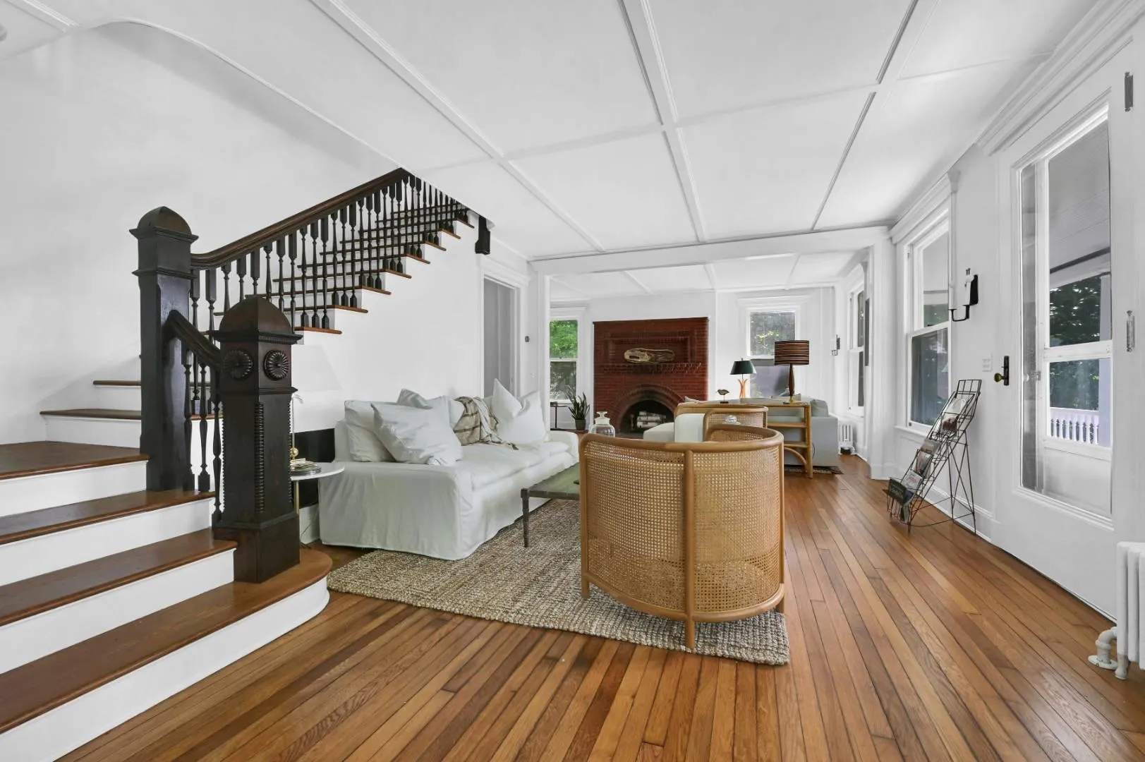 Living room with coffered ceiling, hardwood / wood-style floors, and radiator heating unit Living room with coffered ceiling, hardwood / wood-style floors, and radiator heating unit