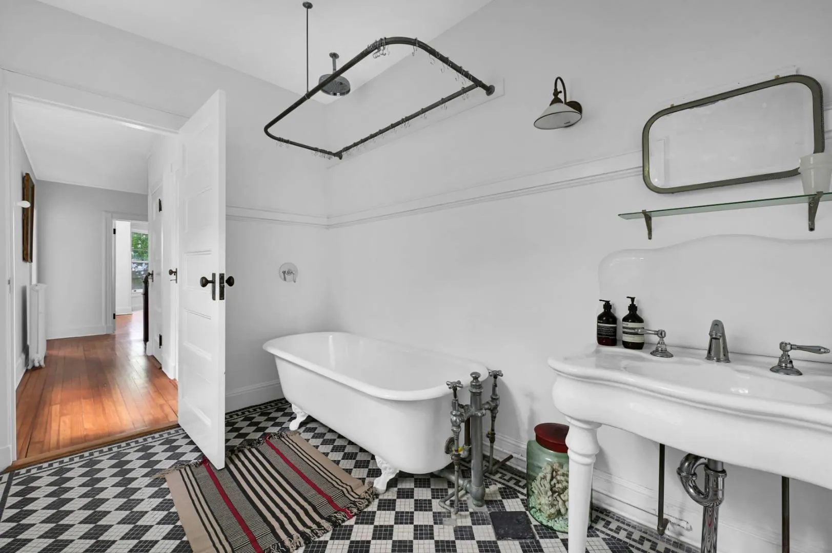 Bathroom featuring a bath, sink, and radiator Bathroom featuring a bath, sink, and radiator