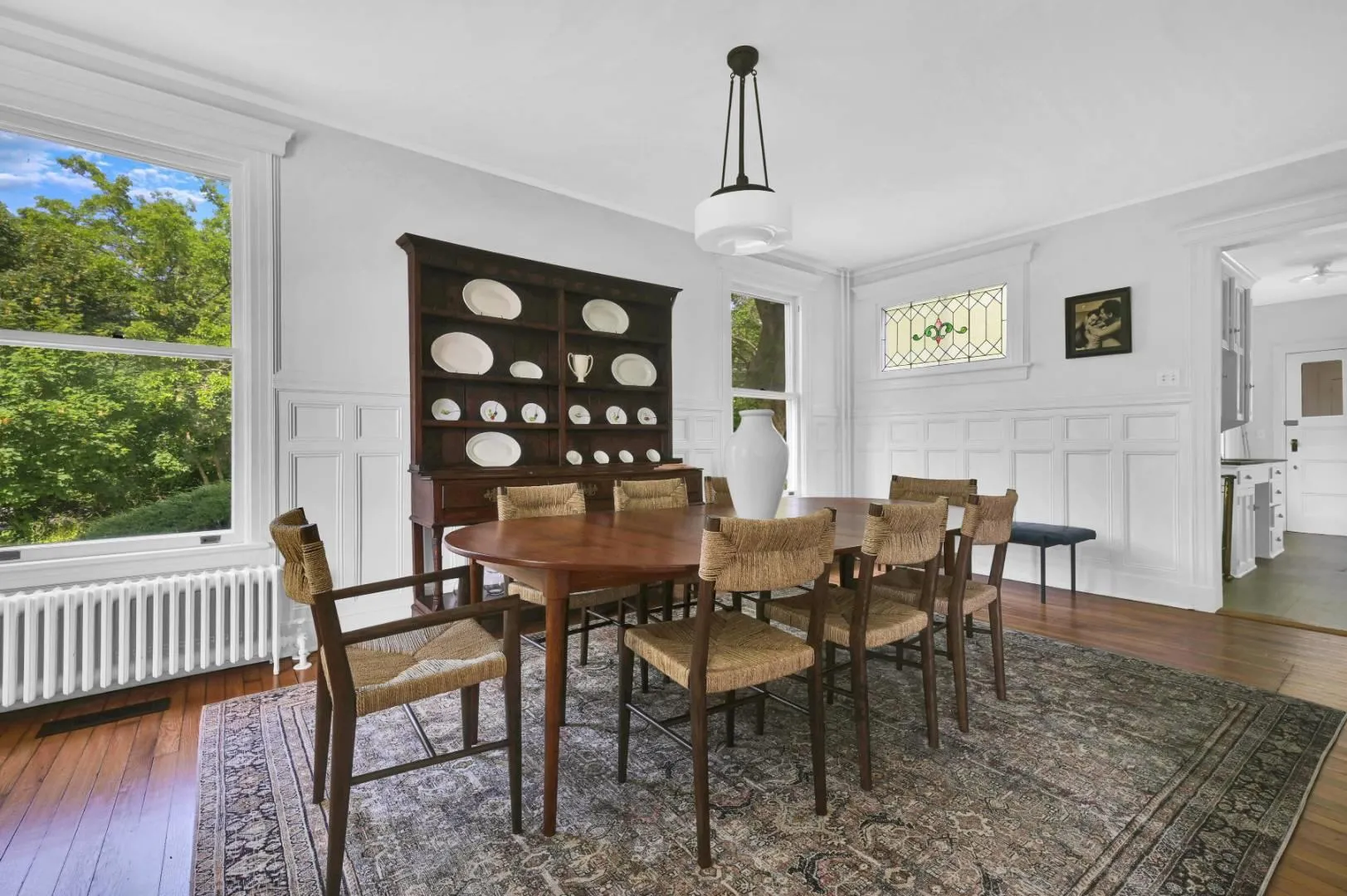 Dining room with radiator and dark hardwood / wood-style floors Dining room with radiator and dark hardwood / wood-style floors