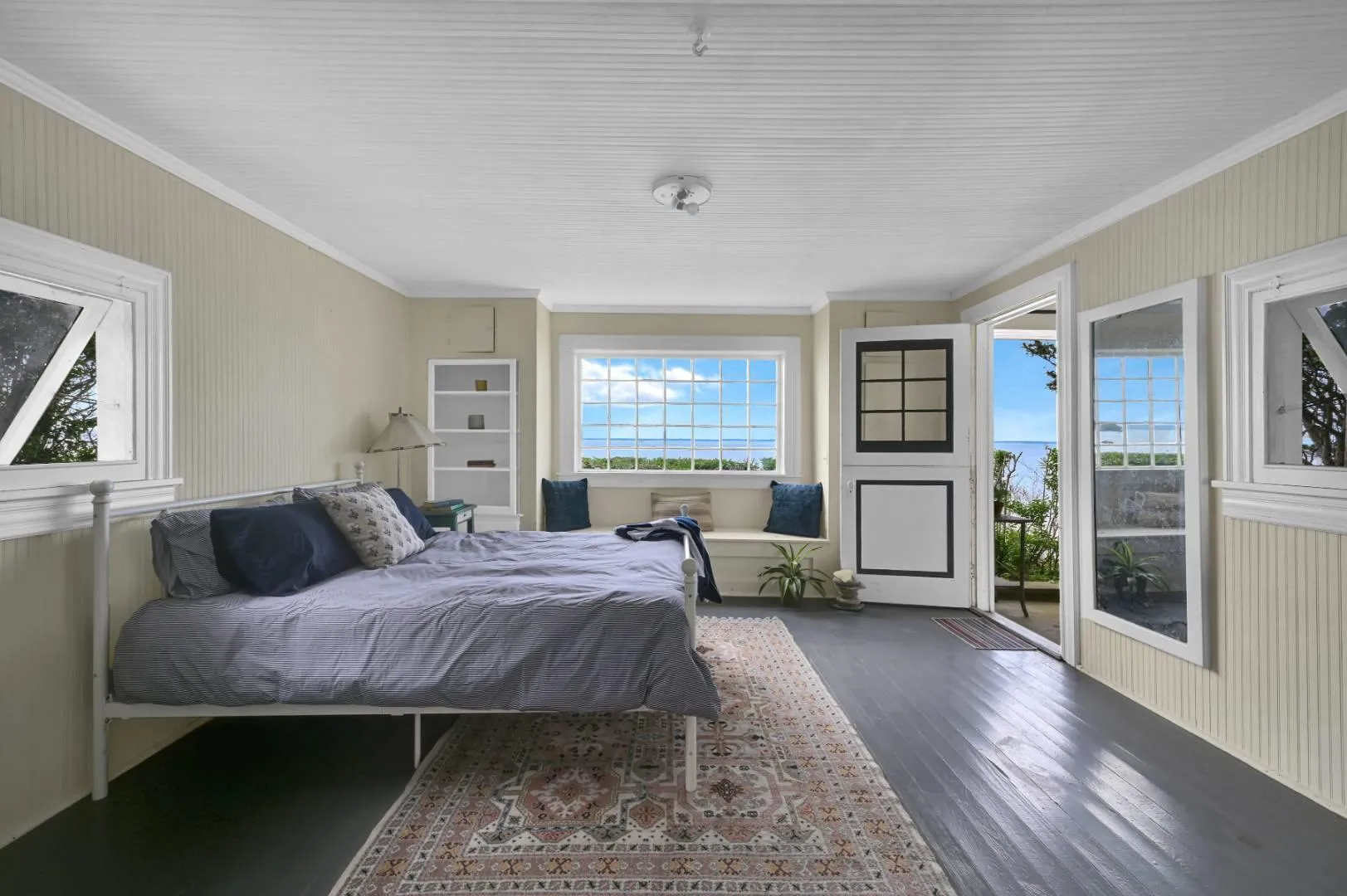 Bedroom with dark wood-type flooring, crown molding, and access to exterior Bedroom with dark wood-type flooring, crown molding, and access to exterior