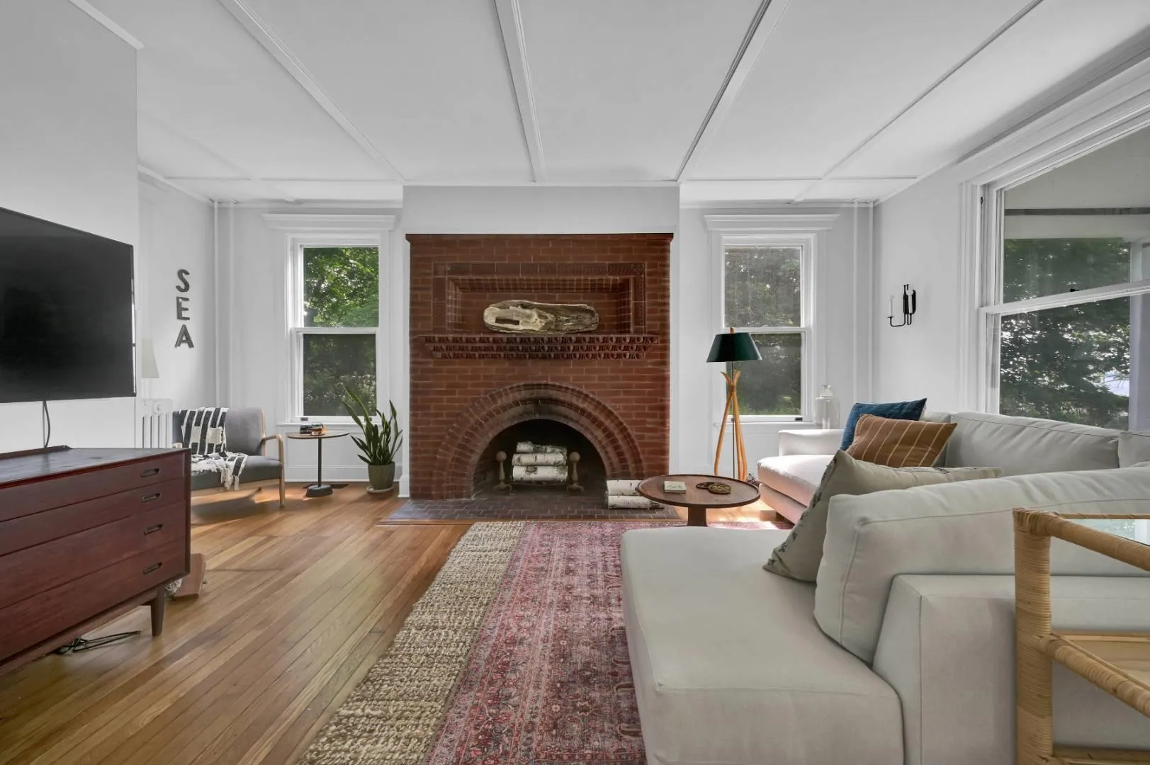 Living room featuring a fireplace and wood-type flooring Living room featuring a fireplace and wood-type flooring