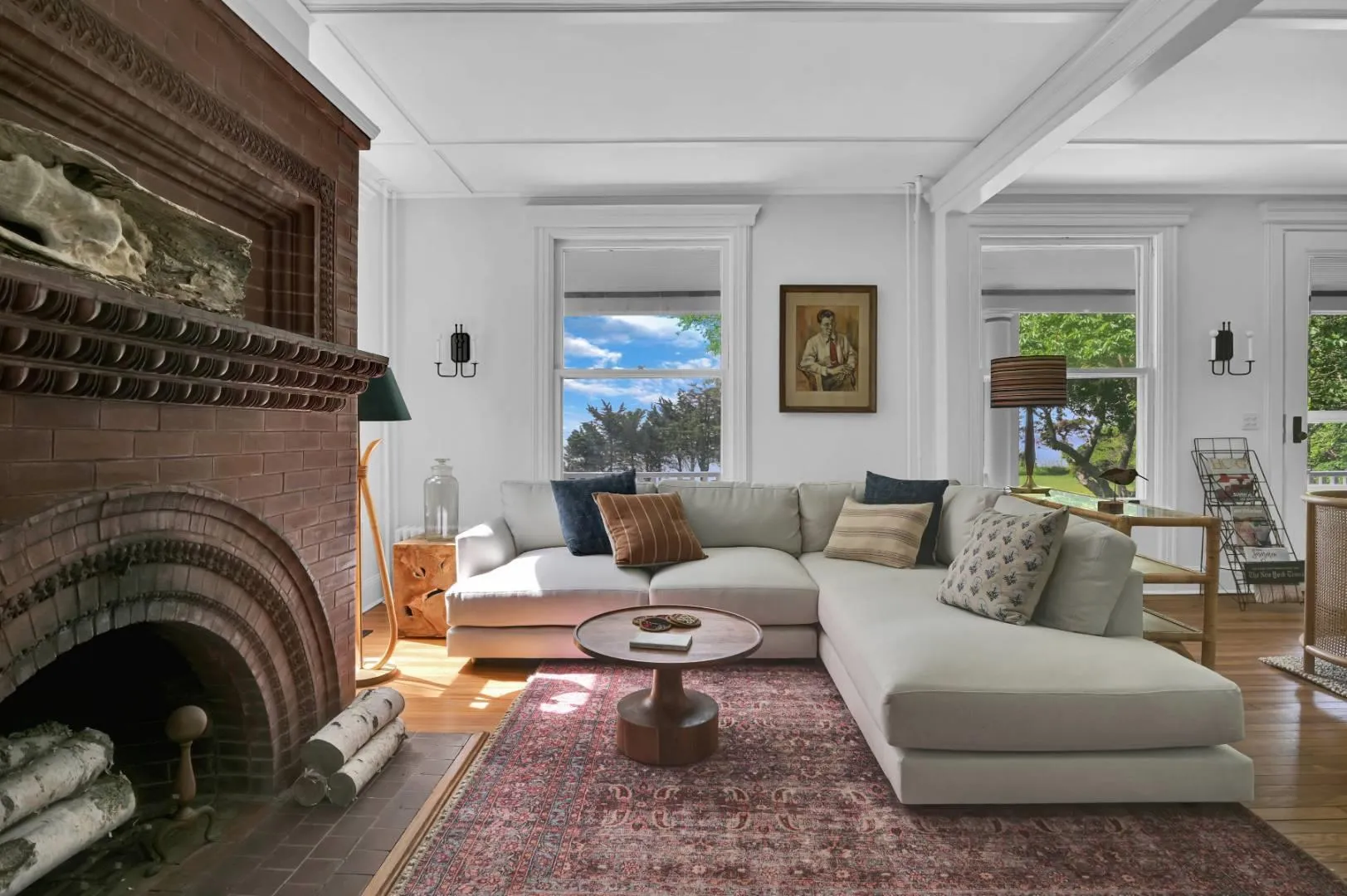 Living room featuring dark wood-type flooring, a fireplace, and beamed ceiling Living room featuring dark wood-type flooring, a fireplace, and beamed ceiling