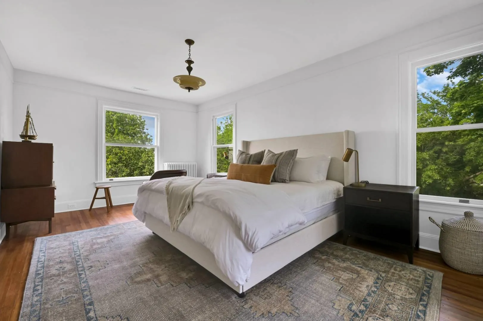Bedroom featuring dark hardwood / wood-style floors and radiator heating unit Bedroom featuring dark hardwood / wood-style floors and radiator heating unit