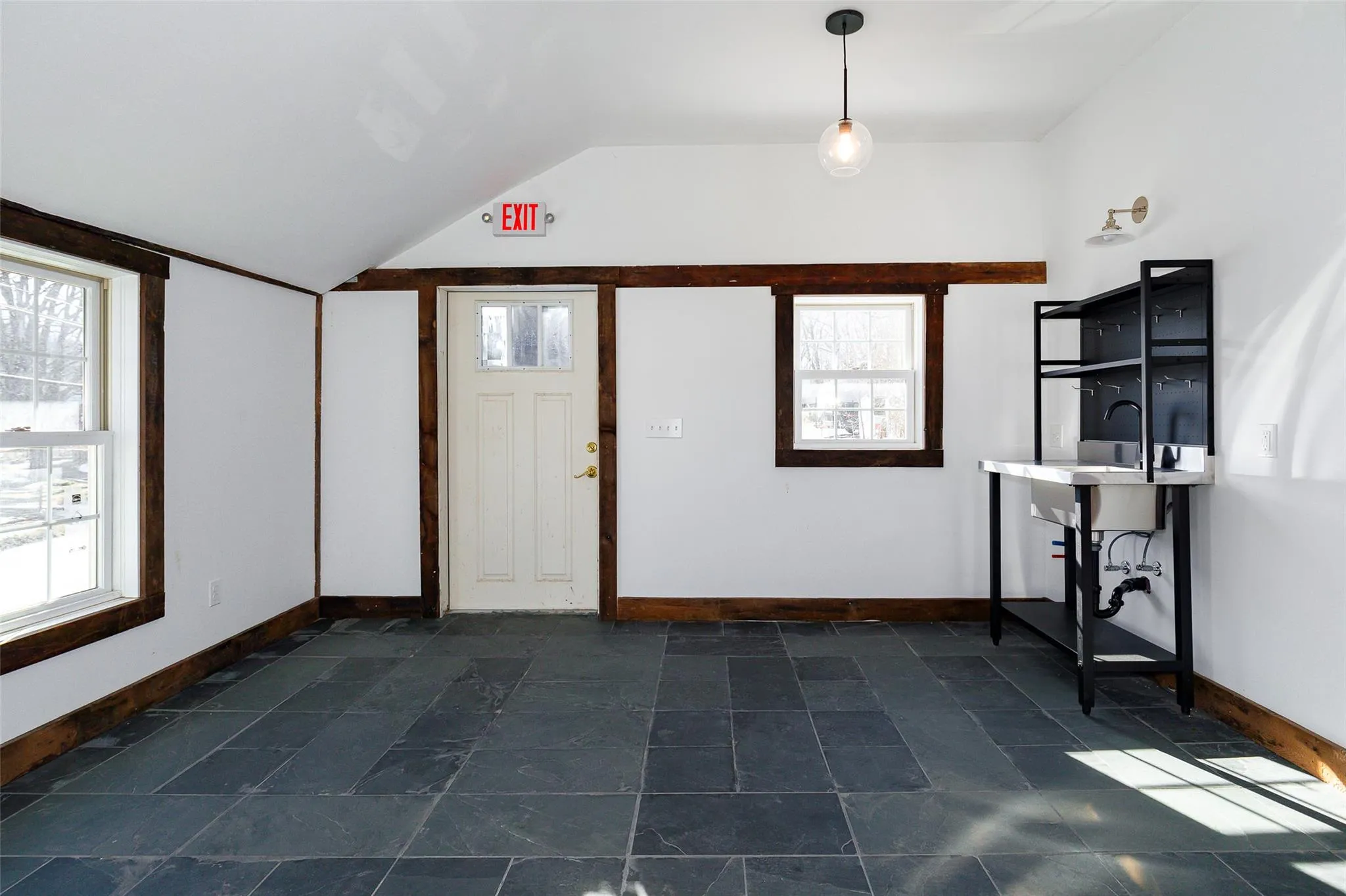 Entrance foyer featuring sink and vaulted ceiling Entrance foyer featuring sink and vaulted ceiling
