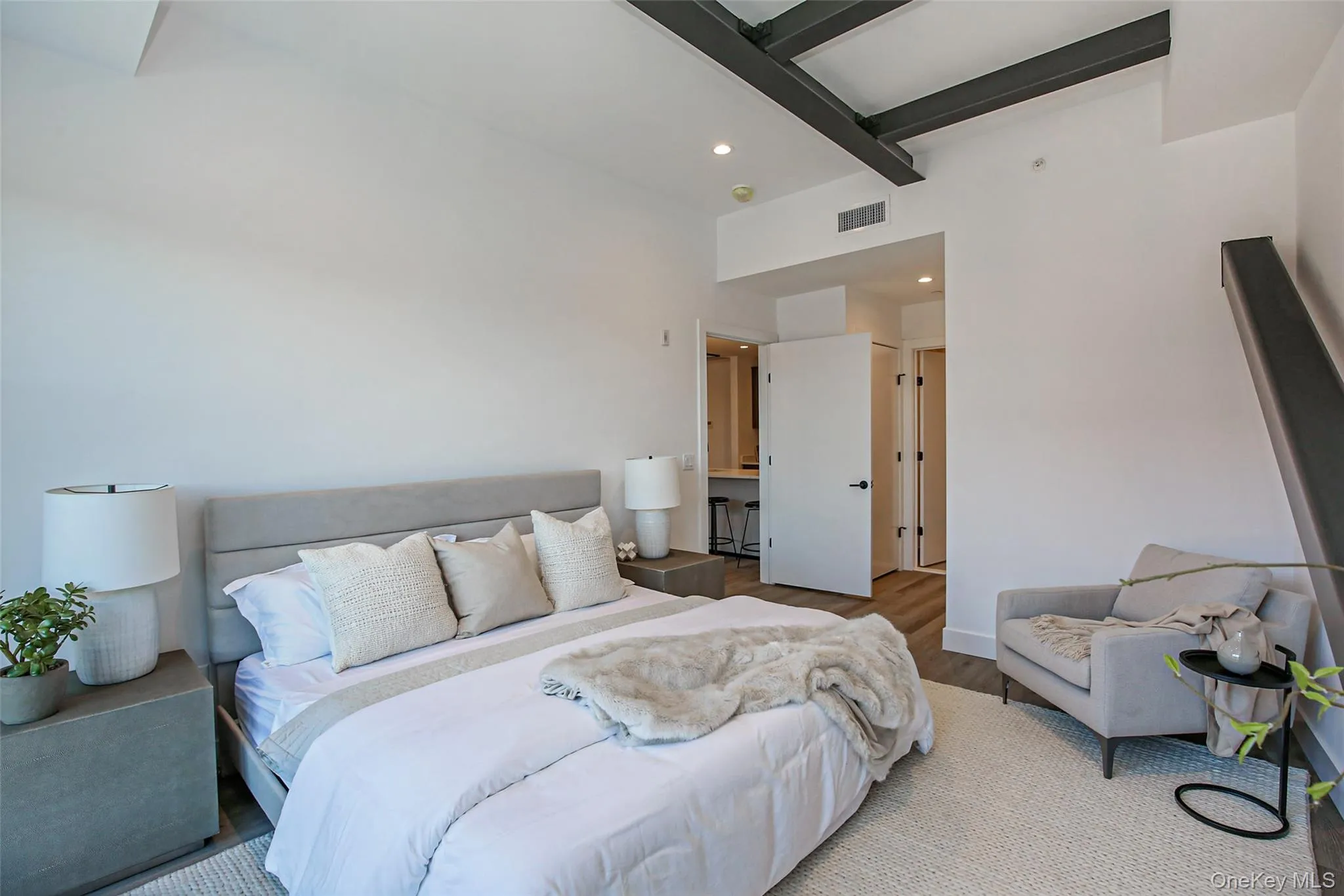 Bedroom with beamed ceiling and light wood-type flooring Bedroom with beamed ceiling and light wood-type flooring