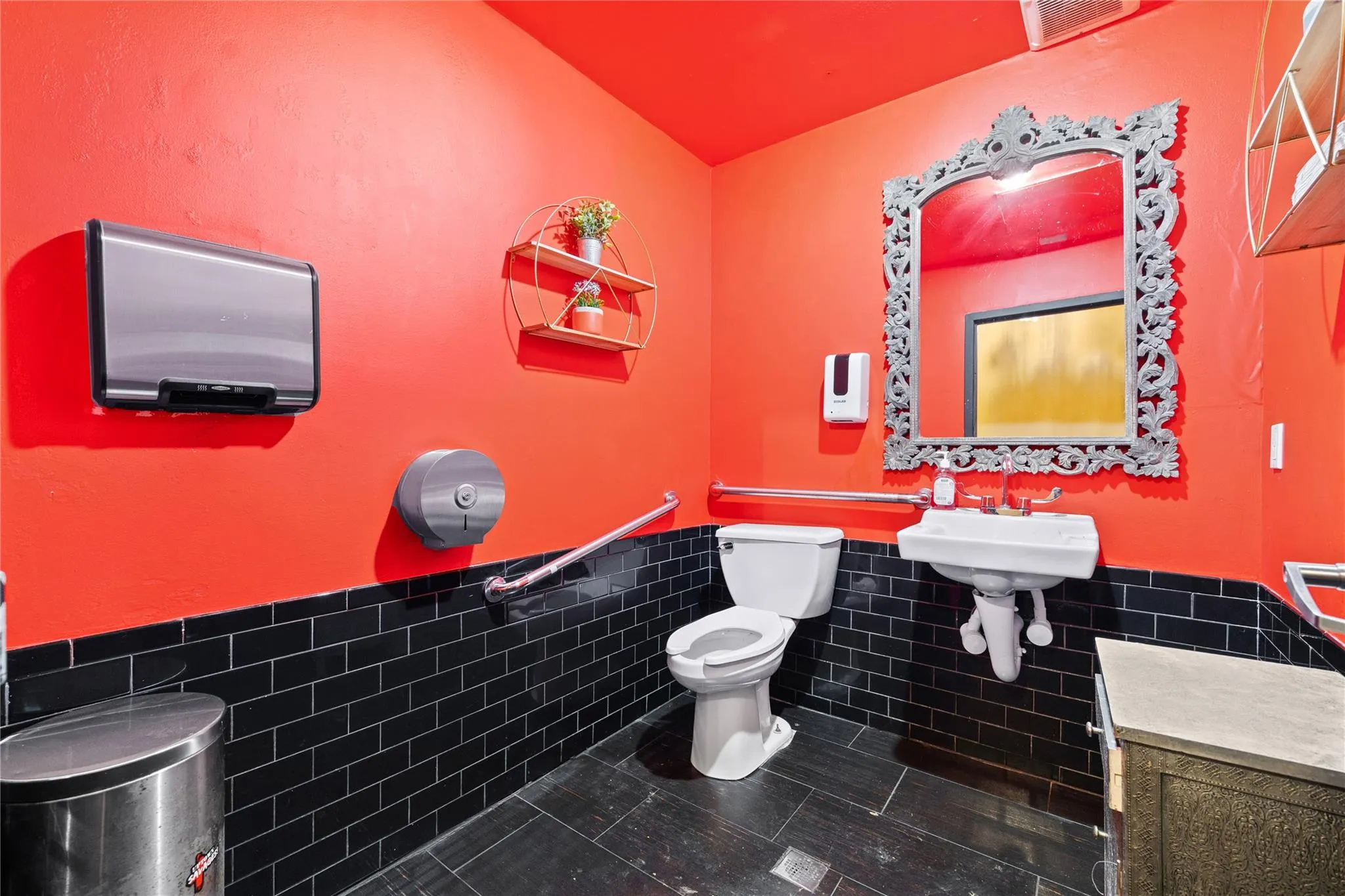 Bathroom with toilet, tile patterned flooring, and tile walls Bathroom with toilet, tile patterned flooring, and tile walls