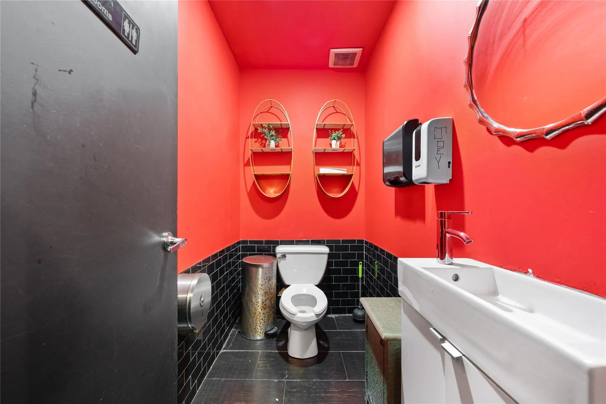 Bathroom featuring tile patterned flooring, vanity, tile walls, and toilet Bathroom featuring tile patterned flooring, vanity, tile walls, and toilet