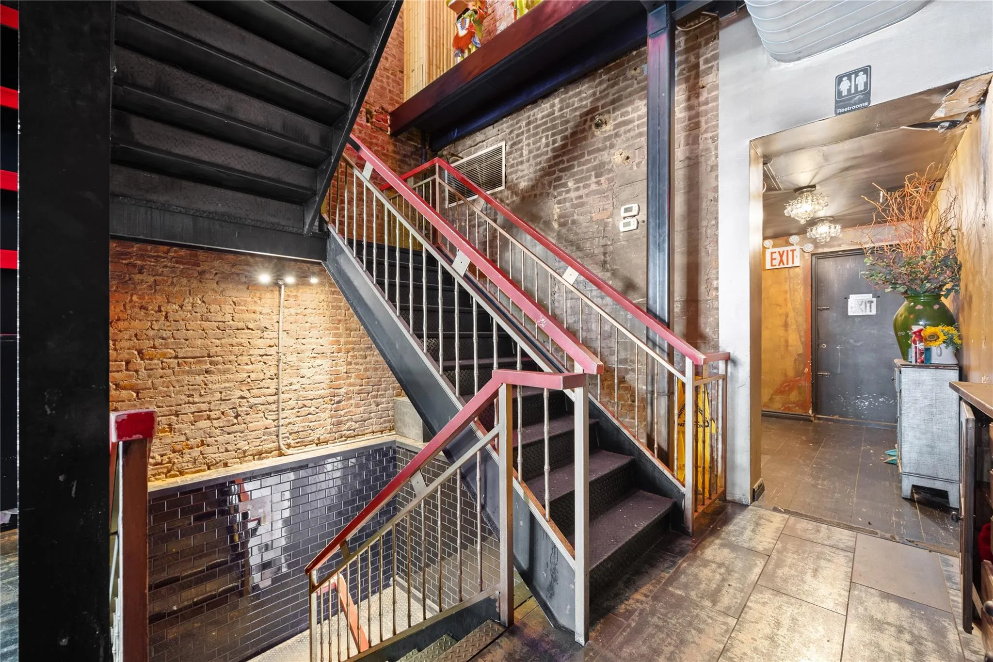 Staircase featuring brick wall Staircase featuring brick wall