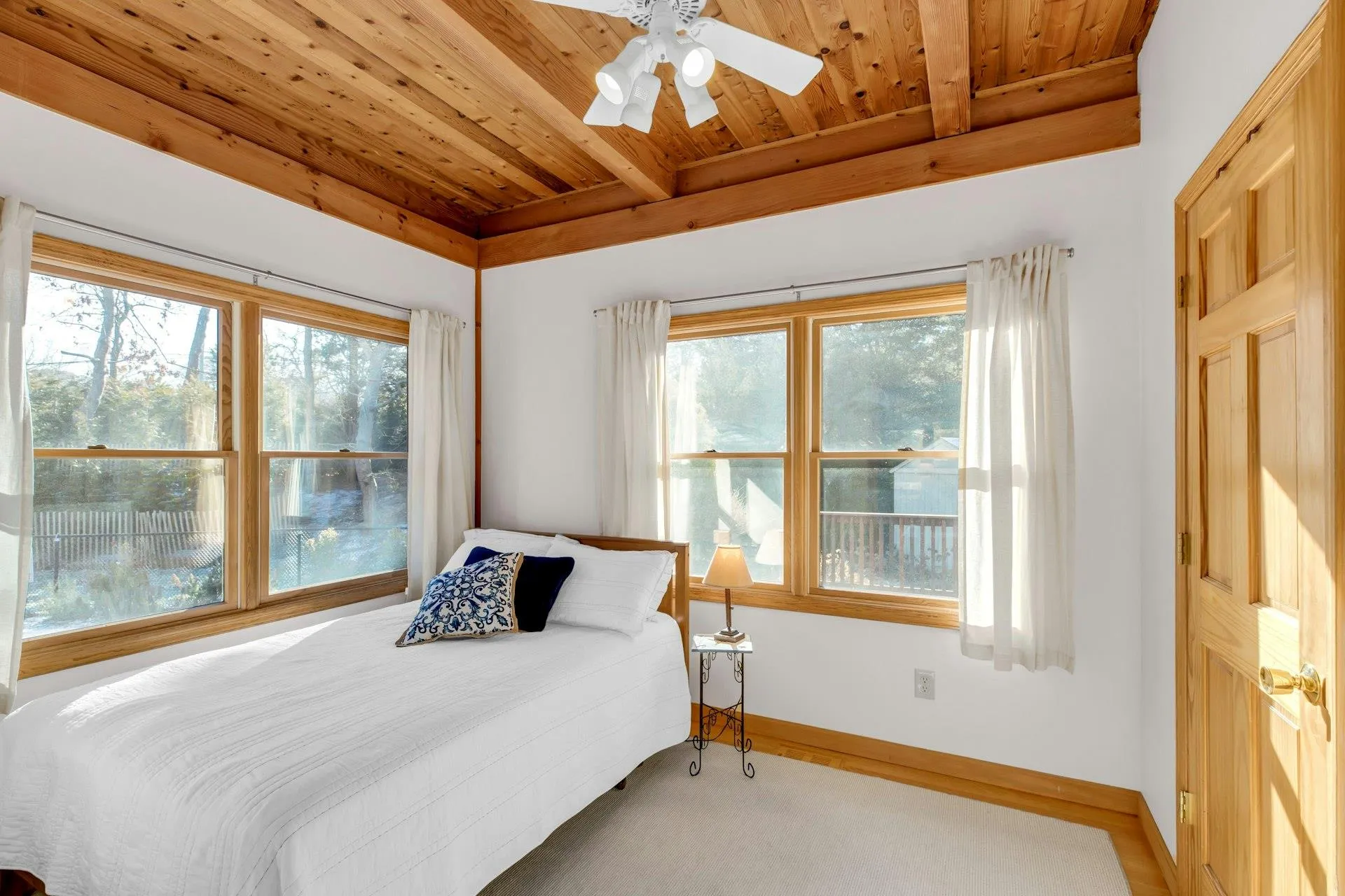 Bedroom with multiple windows, wooden ceiling, and beamed ceiling Bedroom with multiple windows, wooden ceiling, and beamed ceiling
