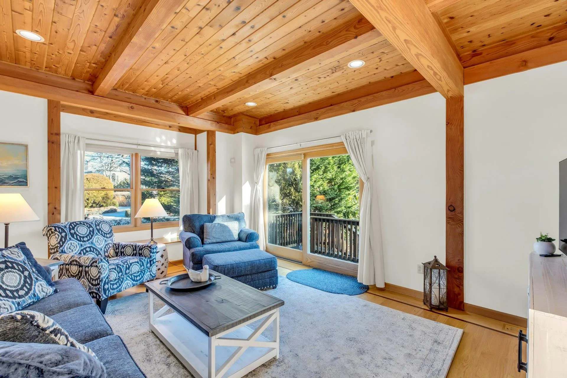 Living room featuring beam ceiling, light hardwood / wood-style flooring, and wooden ceiling Living room featuring beam ceiling, light hardwood / wood-style flooring, and wooden ceiling