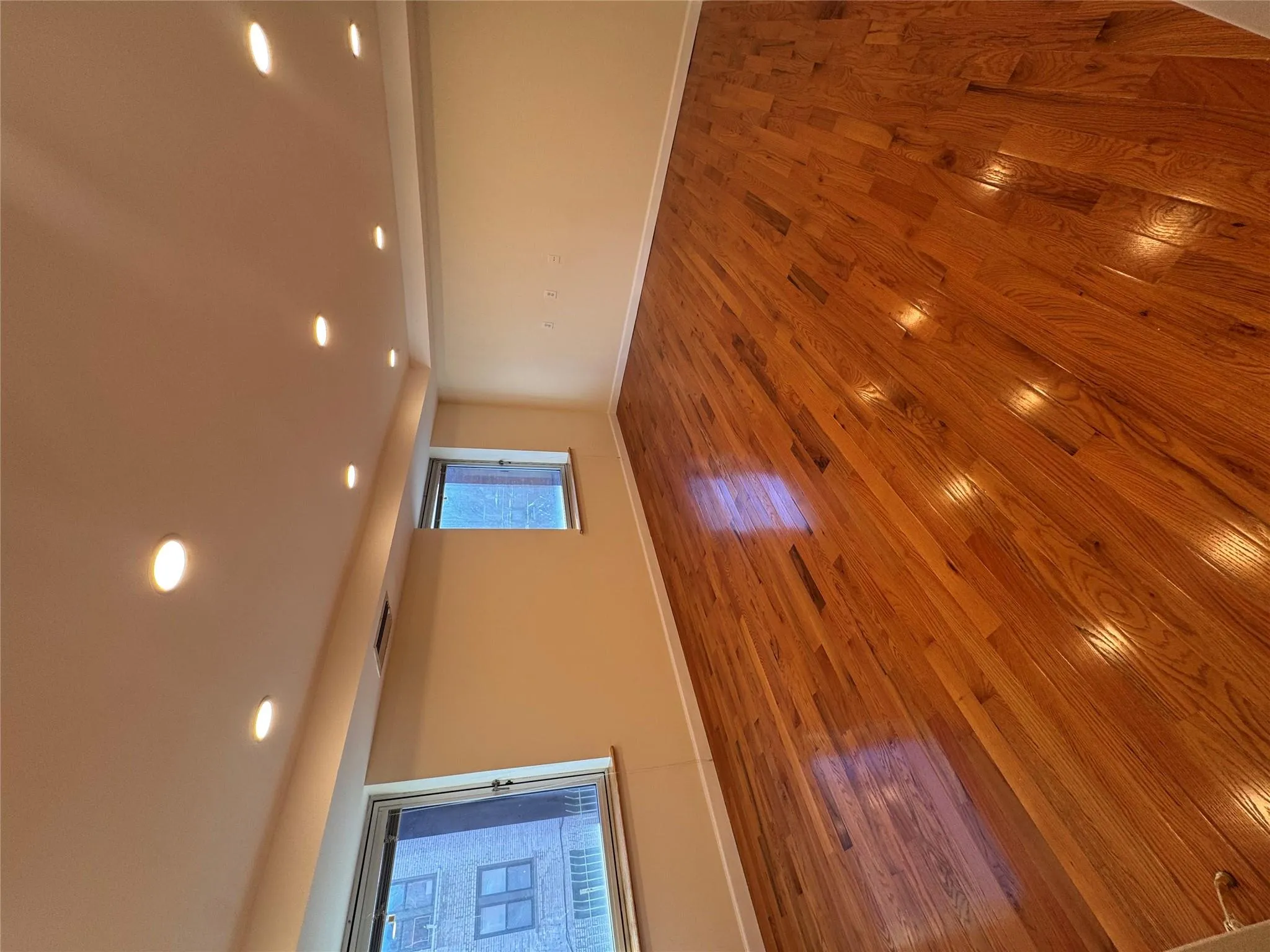 Unfurnished room featuring wood finished floors and recessed lighting Unfurnished room featuring wood finished floors and recessed lighting