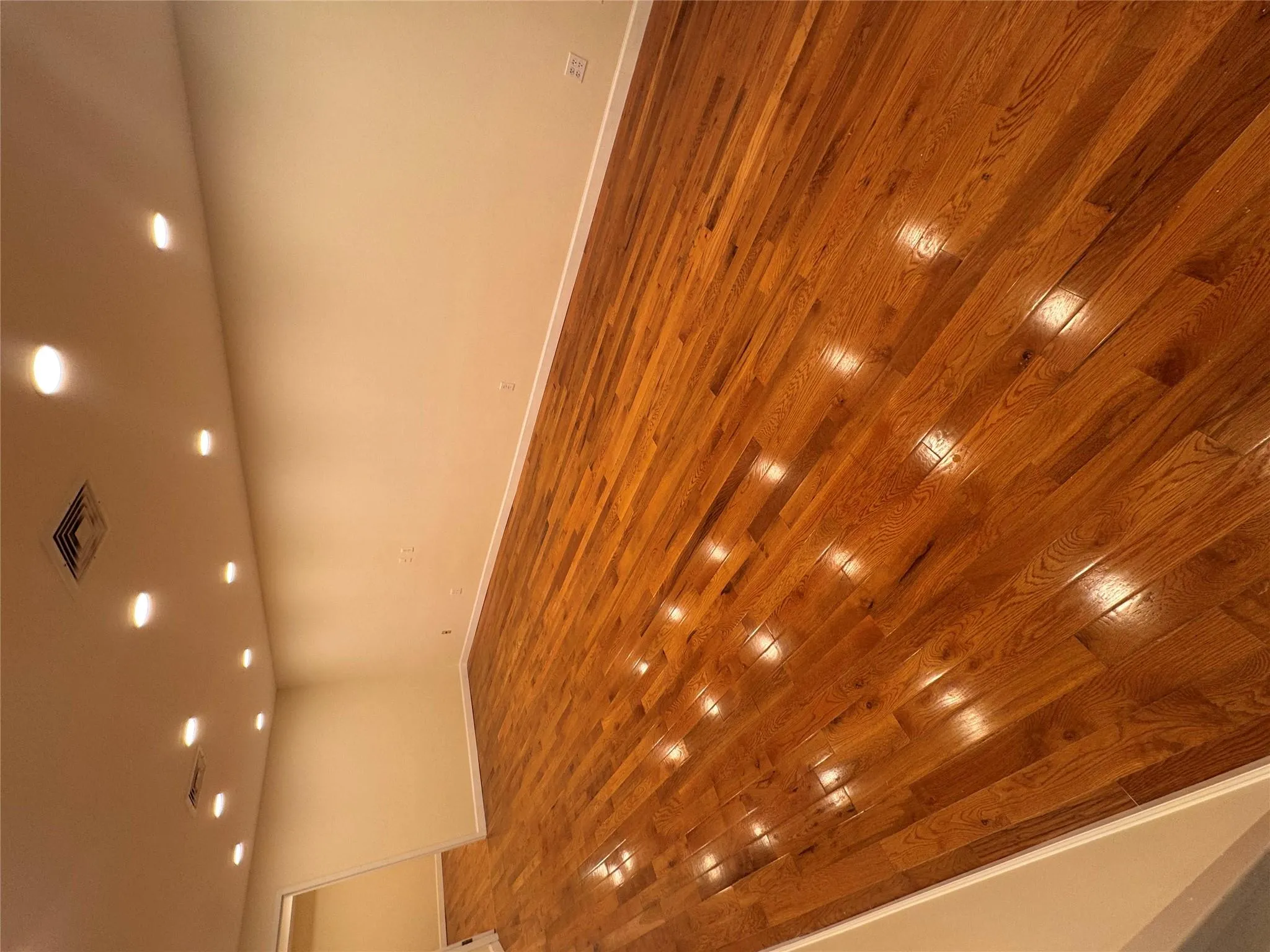 Unfurnished room with wood-type flooring and recessed lighting Unfurnished room with wood-type flooring and recessed lighting