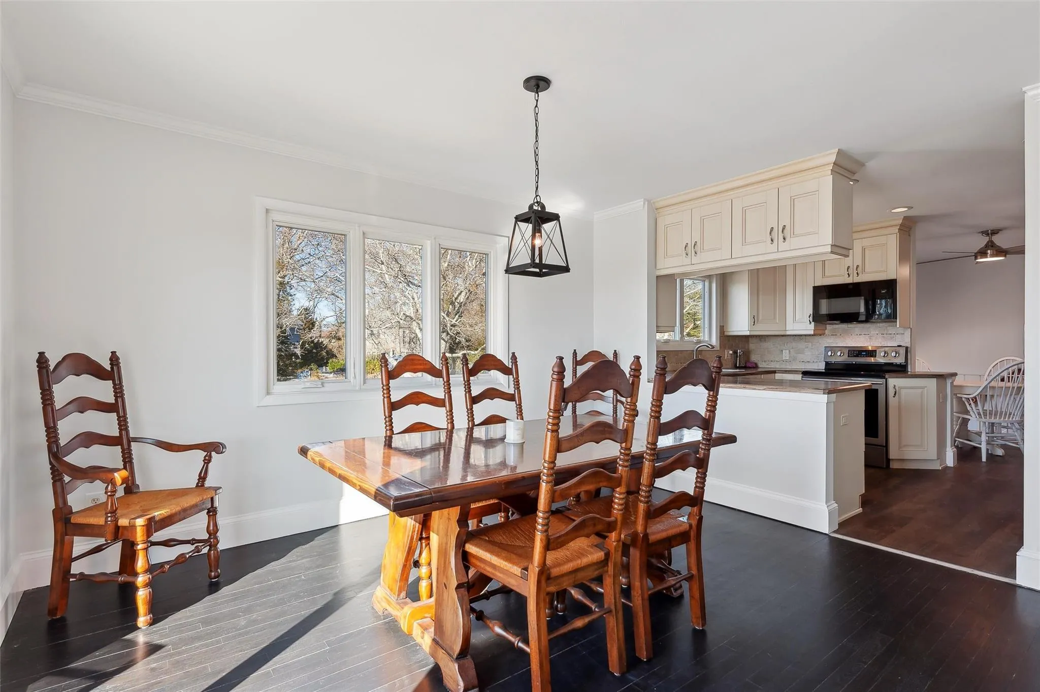 Dining area featuring ornamental molding, dark hardwood / wood-style floors, and ceiling fan Dining area featuring ornamental molding, dark hardwood / wood-style floors, and ceiling fan