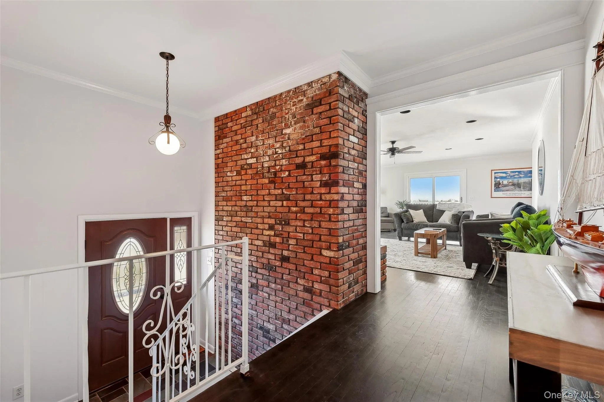 Entryway with ornamental molding, dark hardwood / wood-style floors, and ceiling fan Entryway with ornamental molding, dark hardwood / wood-style floors, and ceiling fan