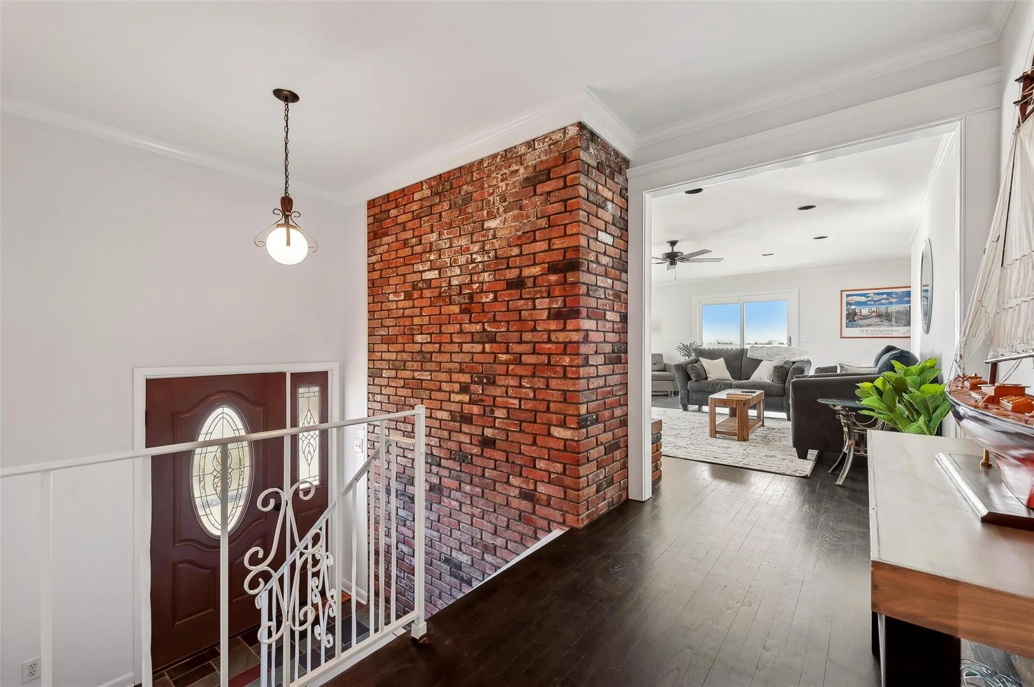 Entryway with ornamental molding, dark hardwood / wood-style floors, and ceiling fan Entryway with ornamental molding, dark hardwood / wood-style floors, and ceiling fan
