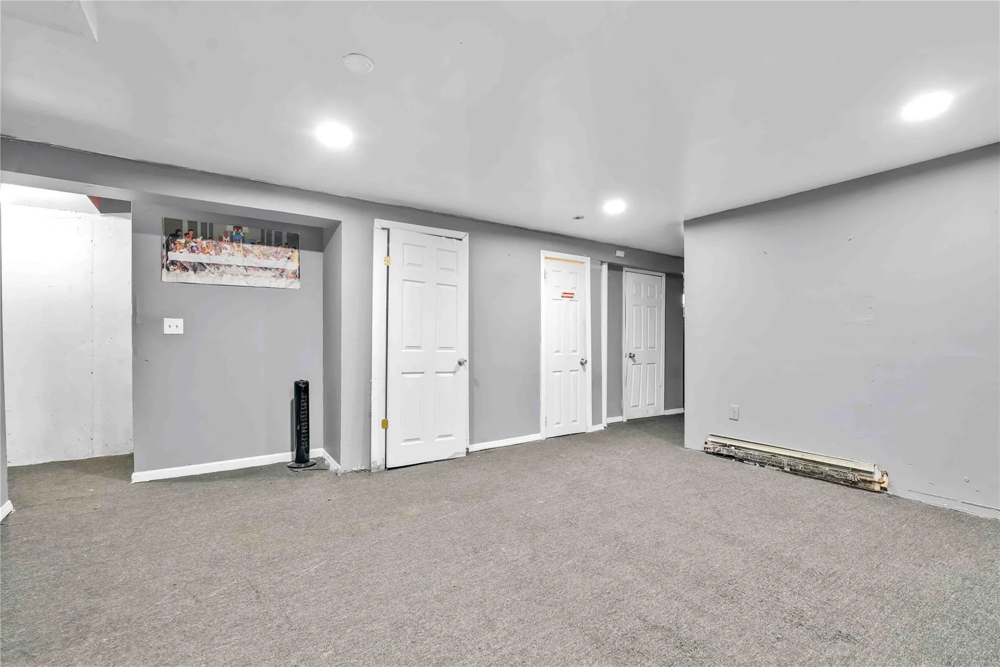 Basement with carpet and a baseboard heating unit Basement with carpet and a baseboard heating unit