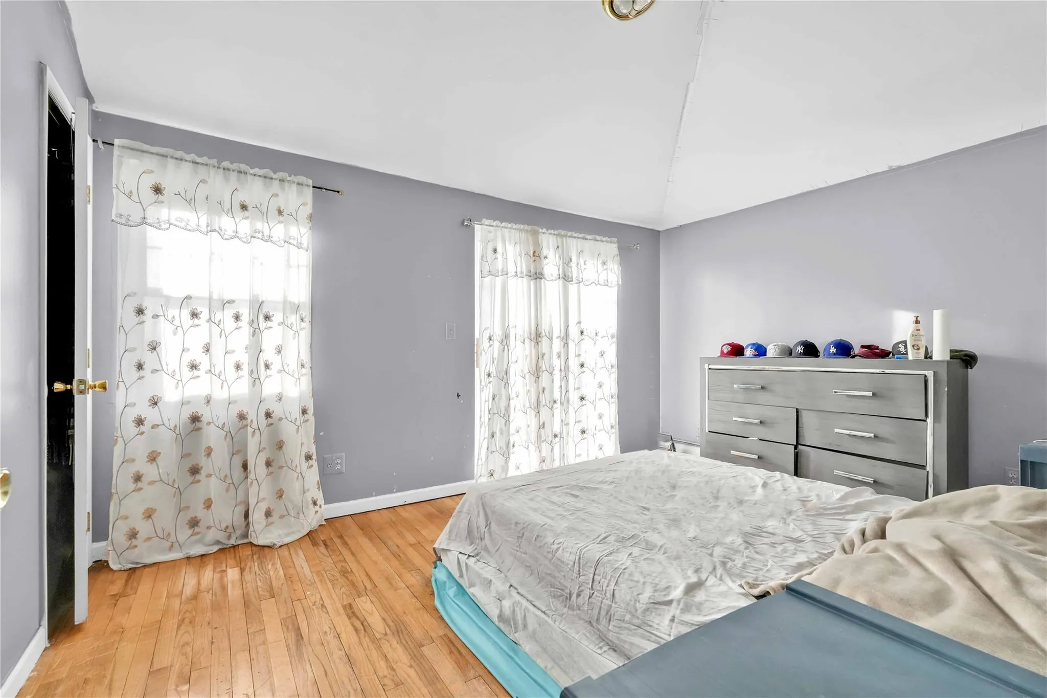 Bedroom featuring lofted ceiling and hardwood / wood-style floors Bedroom featuring lofted ceiling and hardwood / wood-style floors