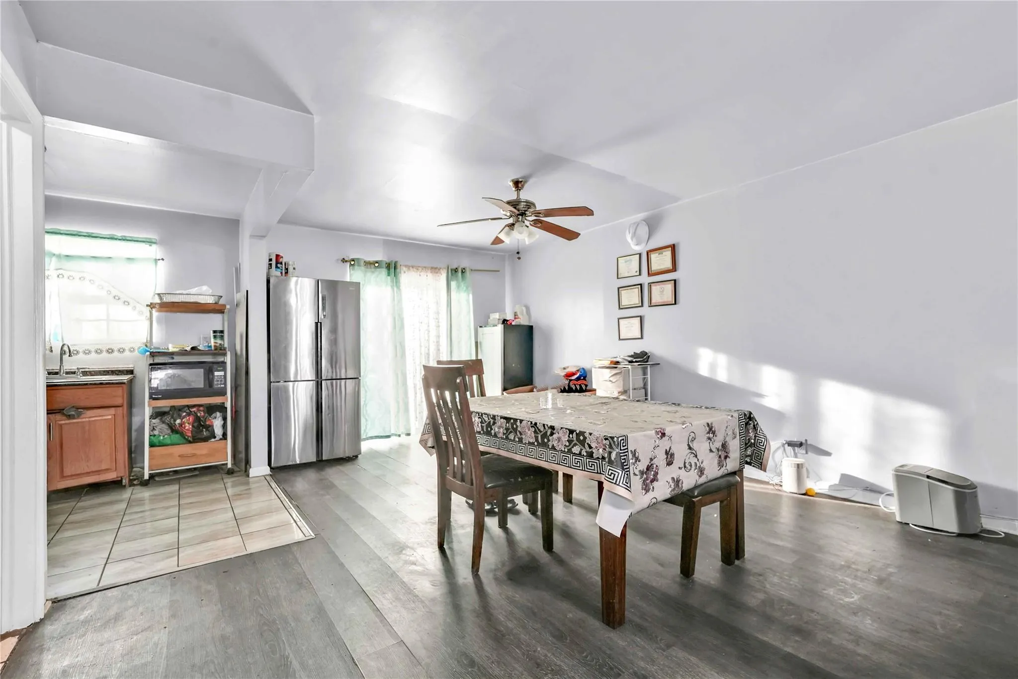 Dining area featuring dark wood-type flooring and ceiling fan Dining area featuring dark wood-type flooring and ceiling fan