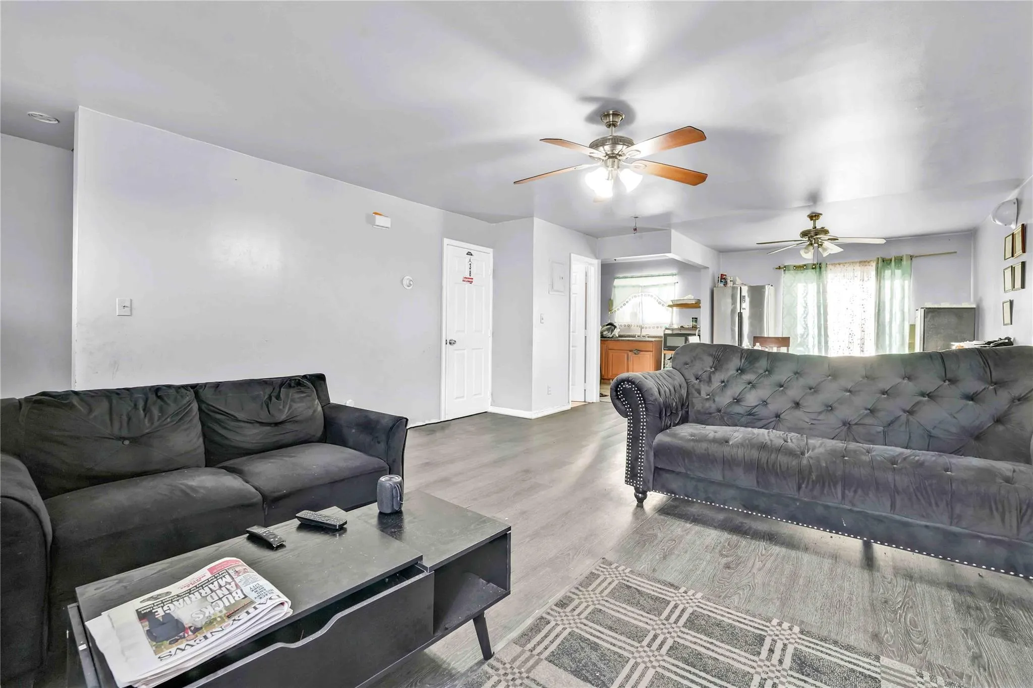 Living room featuring wood-type flooring and ceiling fan Living room featuring wood-type flooring and ceiling fan