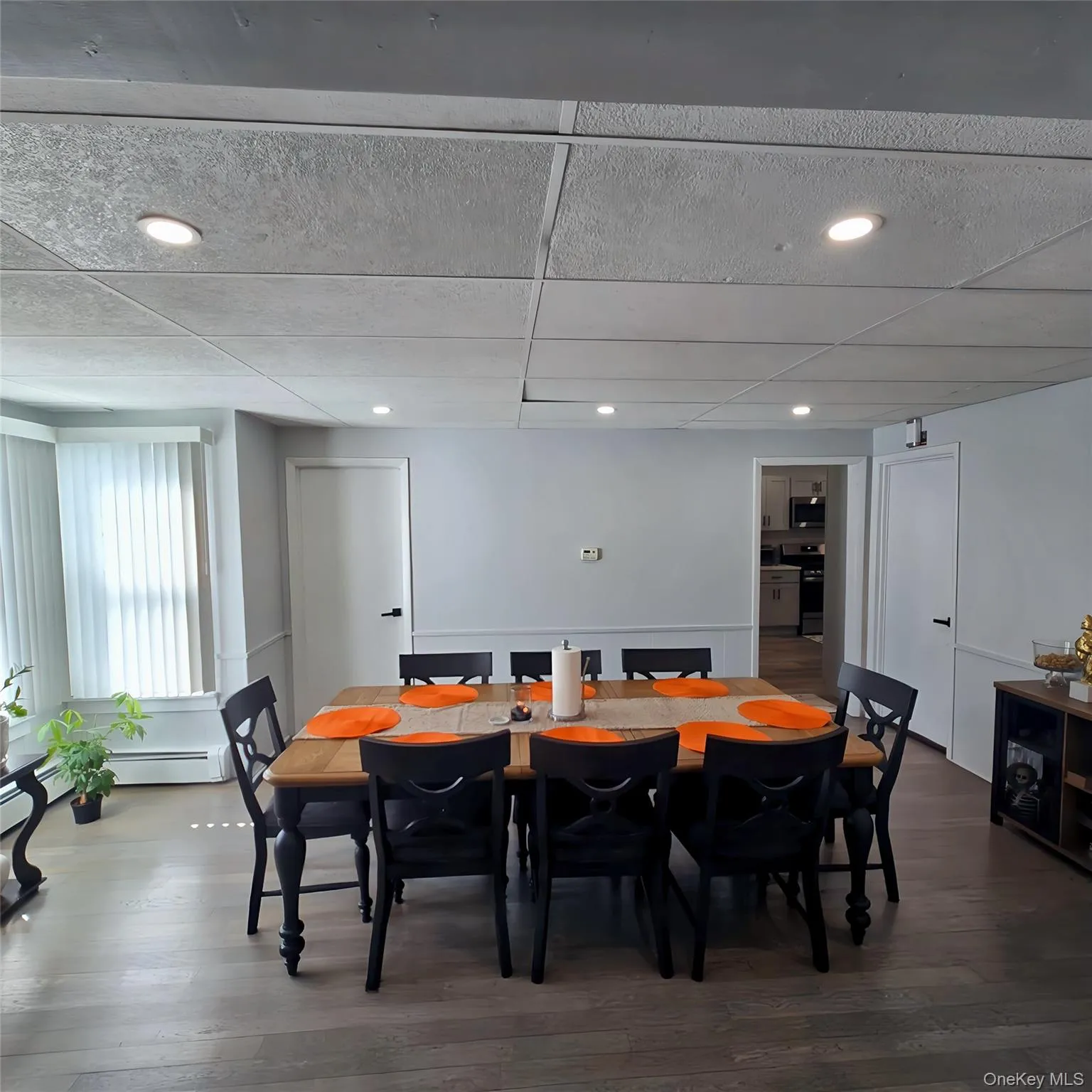 Dining area with recessed lighting, a drop ceiling, and wood finished floors Dining area with recessed lighting, a drop ceiling, and wood finished floors