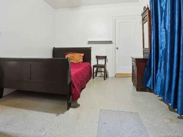Bedroom with light flooring and ornamental molding Bedroom with light flooring and ornamental molding