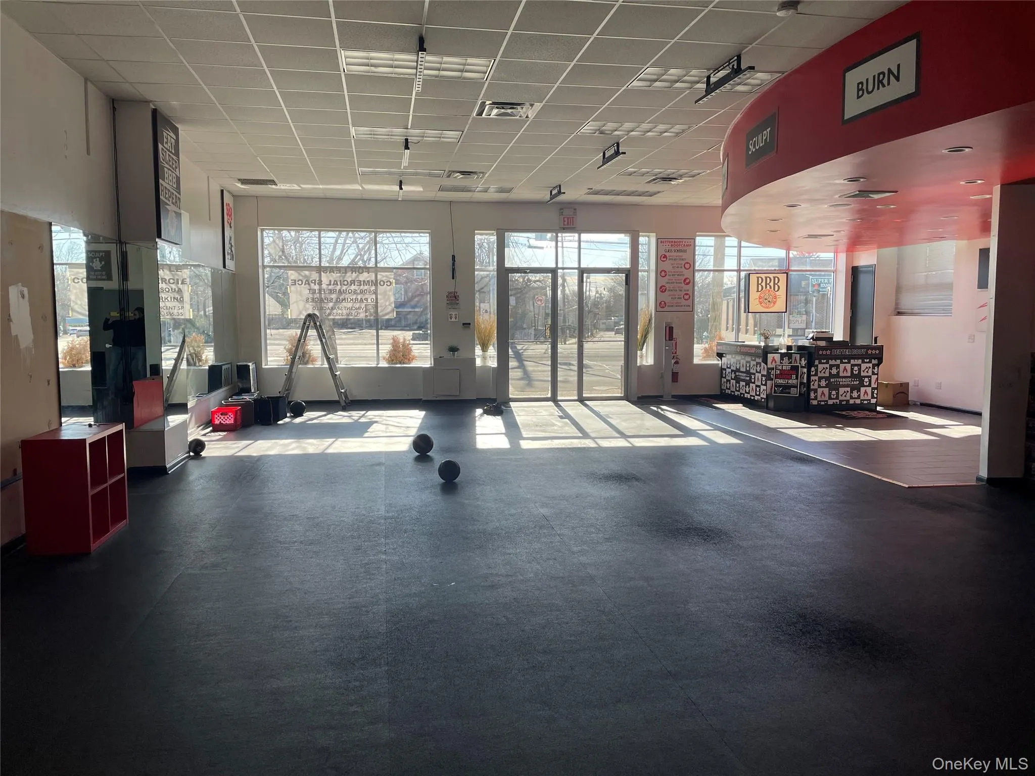 Workout area with a drop ceiling and a wealth of natural light Workout area with a drop ceiling and a wealth of natural light