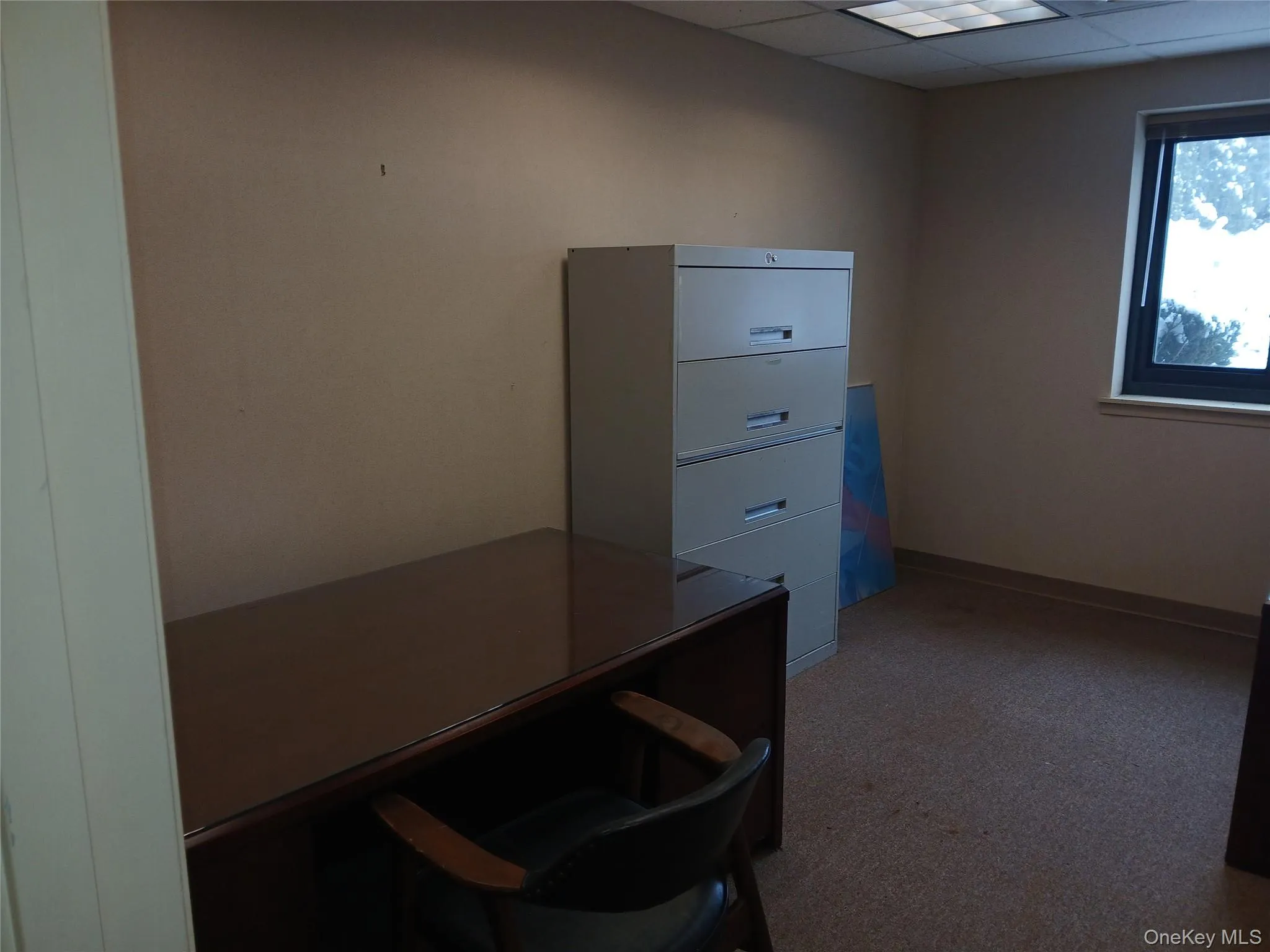 Office space featuring a drop ceiling Office space featuring a drop ceiling