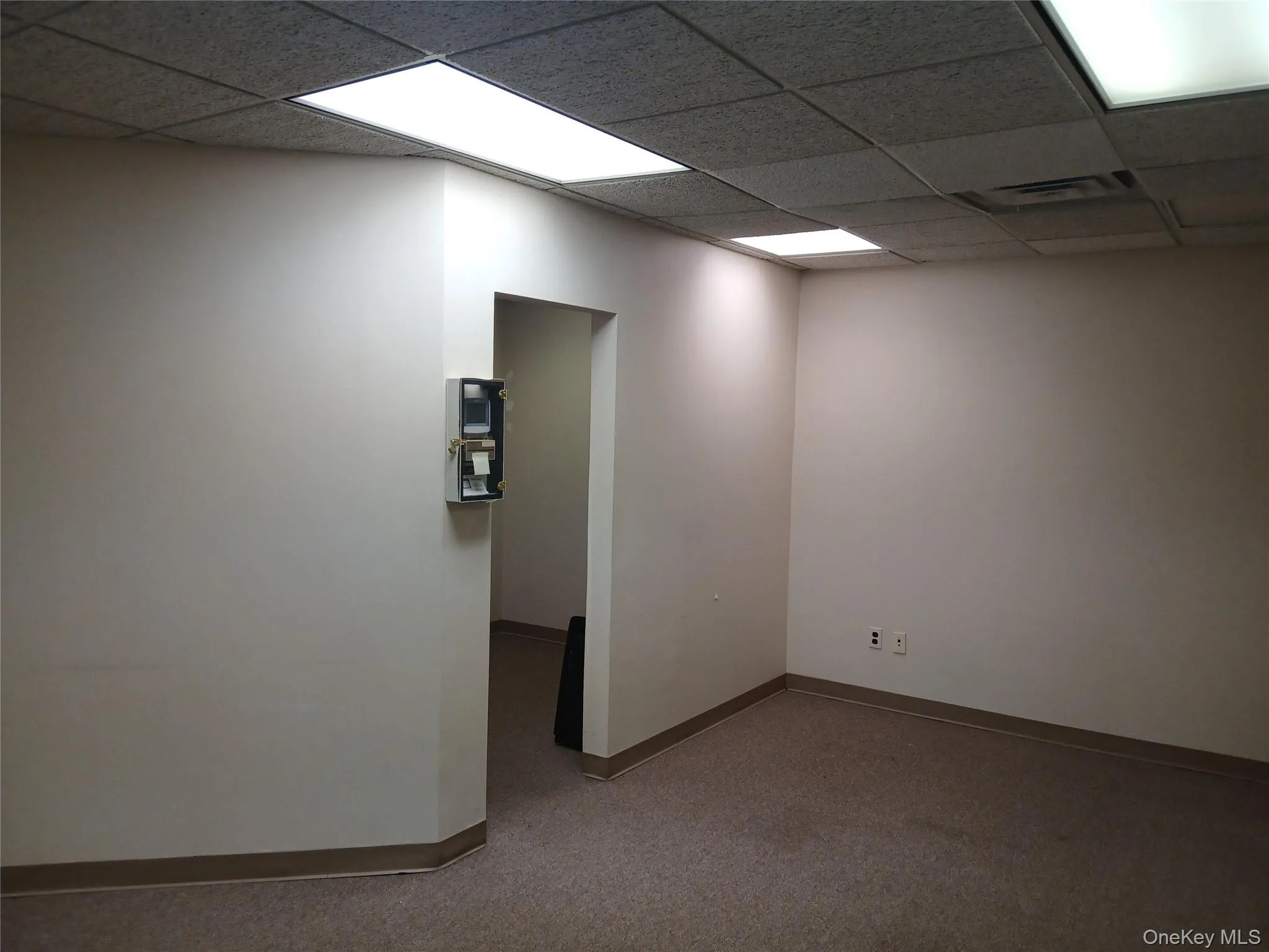 Empty room with a paneled ceiling Empty room with a paneled ceiling