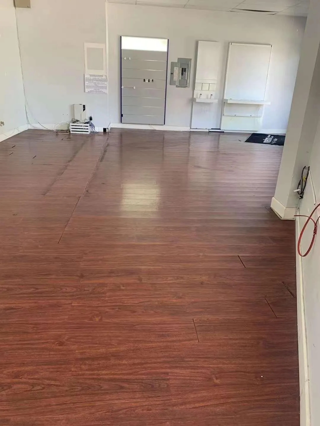 Spare room with a mail area, dark hardwood / wood-style floors, and electric panel Spare room with a mail area, dark hardwood / wood-style floors, and electric panel