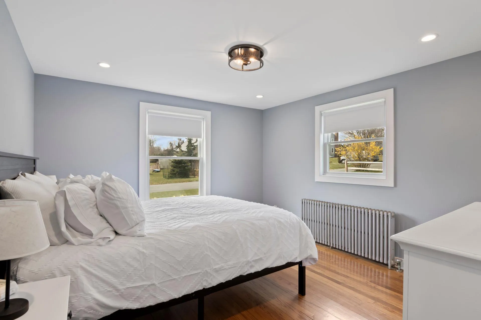 Bedroom with radiator and hardwood / wood-style flooring Bedroom with radiator and hardwood / wood-style flooring