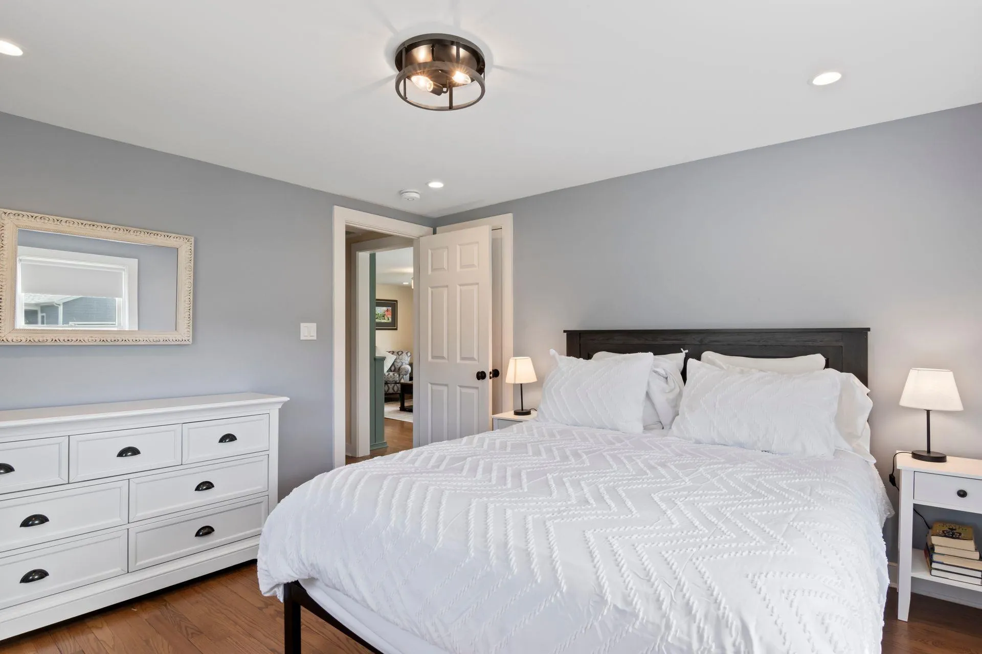 Bedroom featuring dark hardwood / wood-style floors Bedroom featuring dark hardwood / wood-style floors