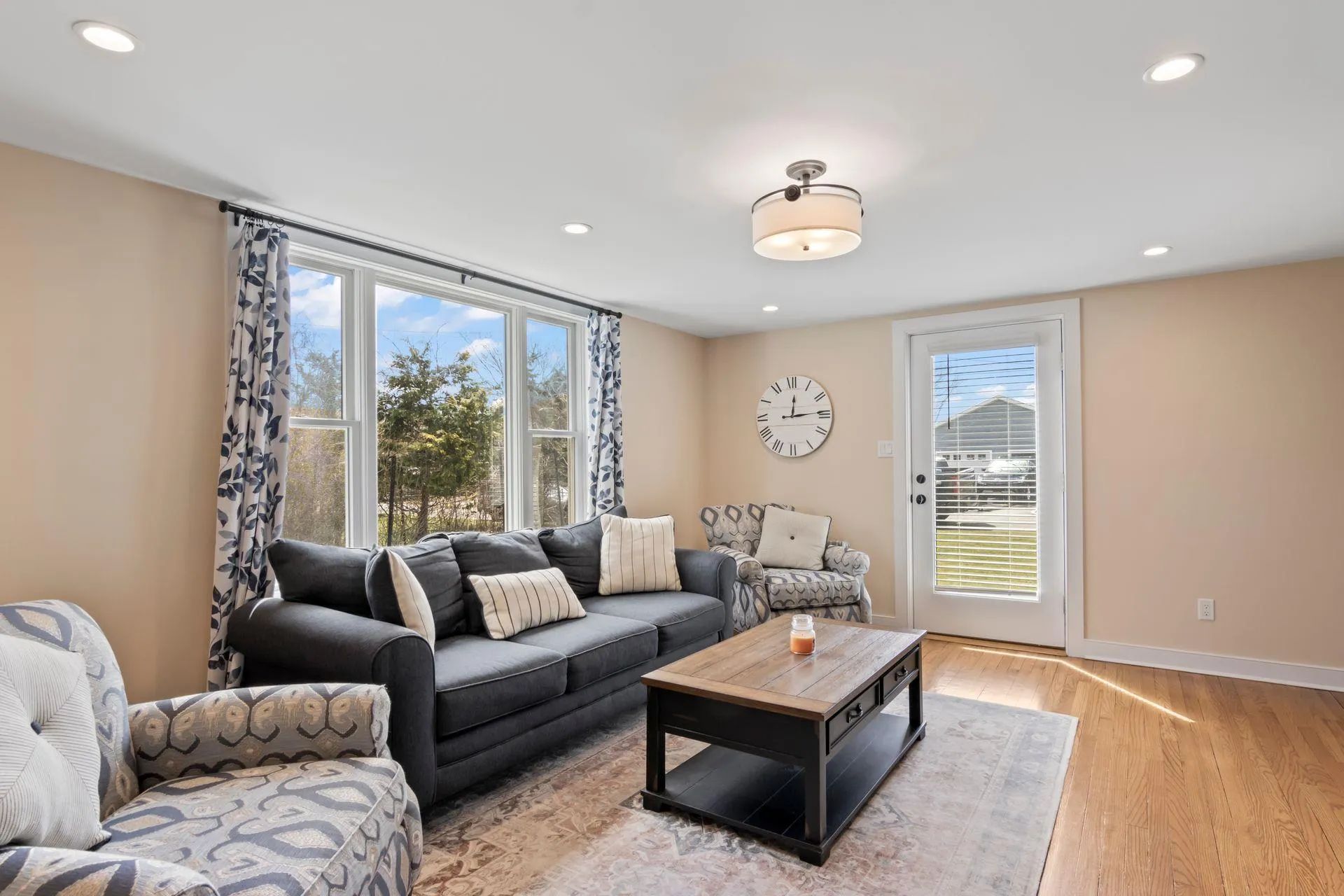 Living room with plenty of natural light and light hardwood / wood-style floors Living room with plenty of natural light and light hardwood / wood-style floors