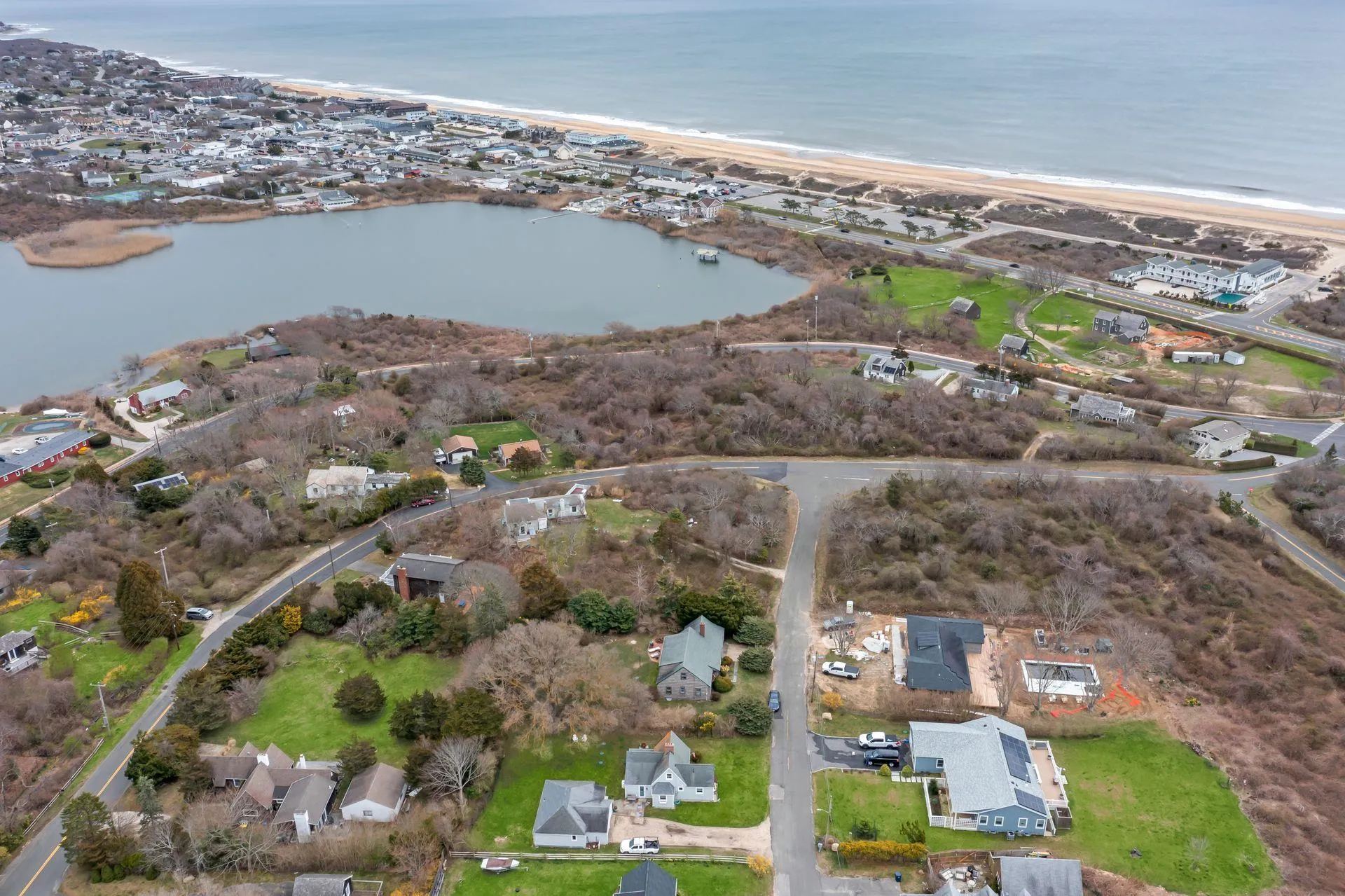 Aerial view featuring a view of the beach and a water view Aerial view featuring a view of the beach and a water view