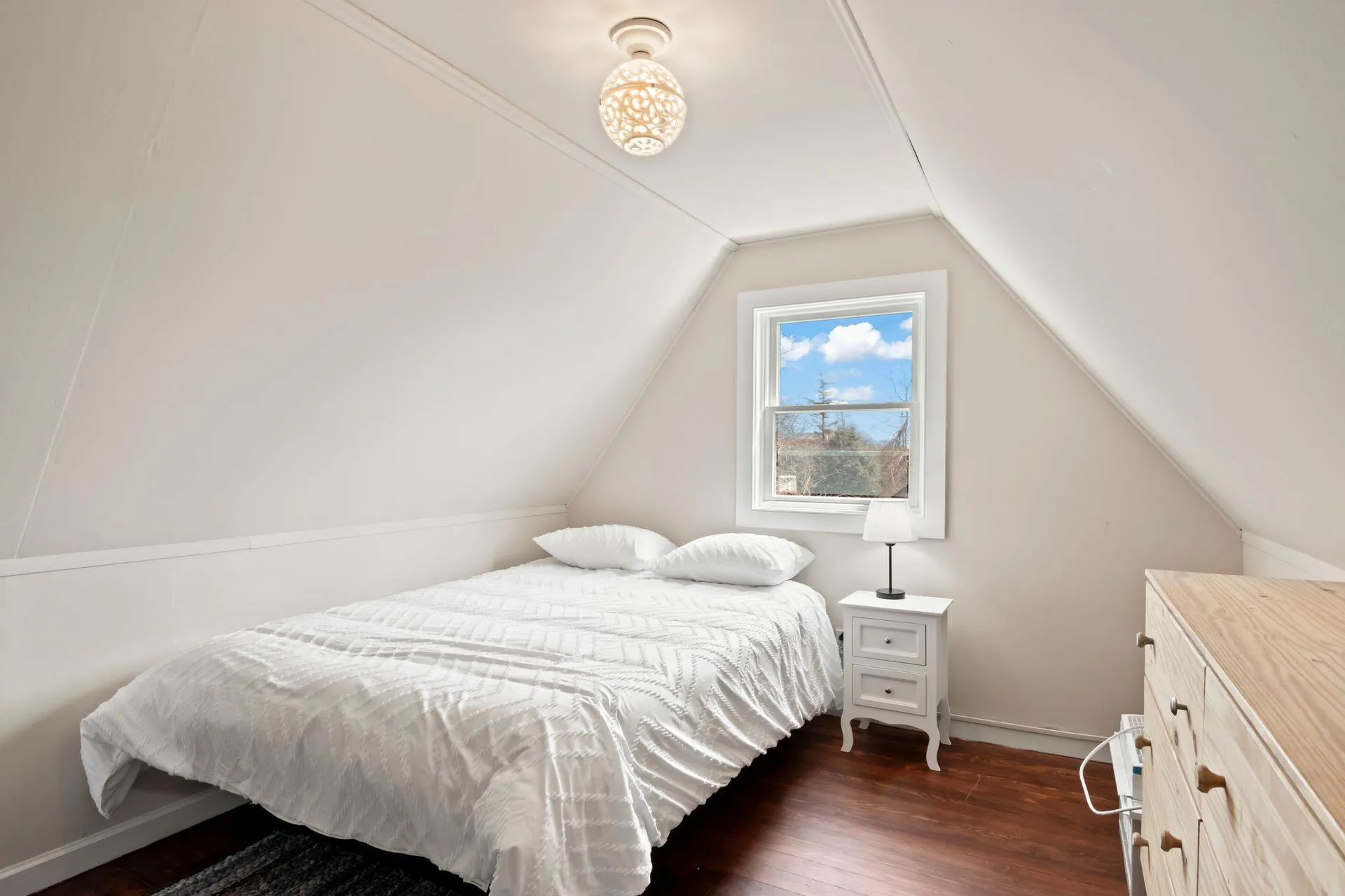 Bedroom with dark hardwood / wood-style flooring and vaulted ceiling Bedroom with dark hardwood / wood-style flooring and vaulted ceiling